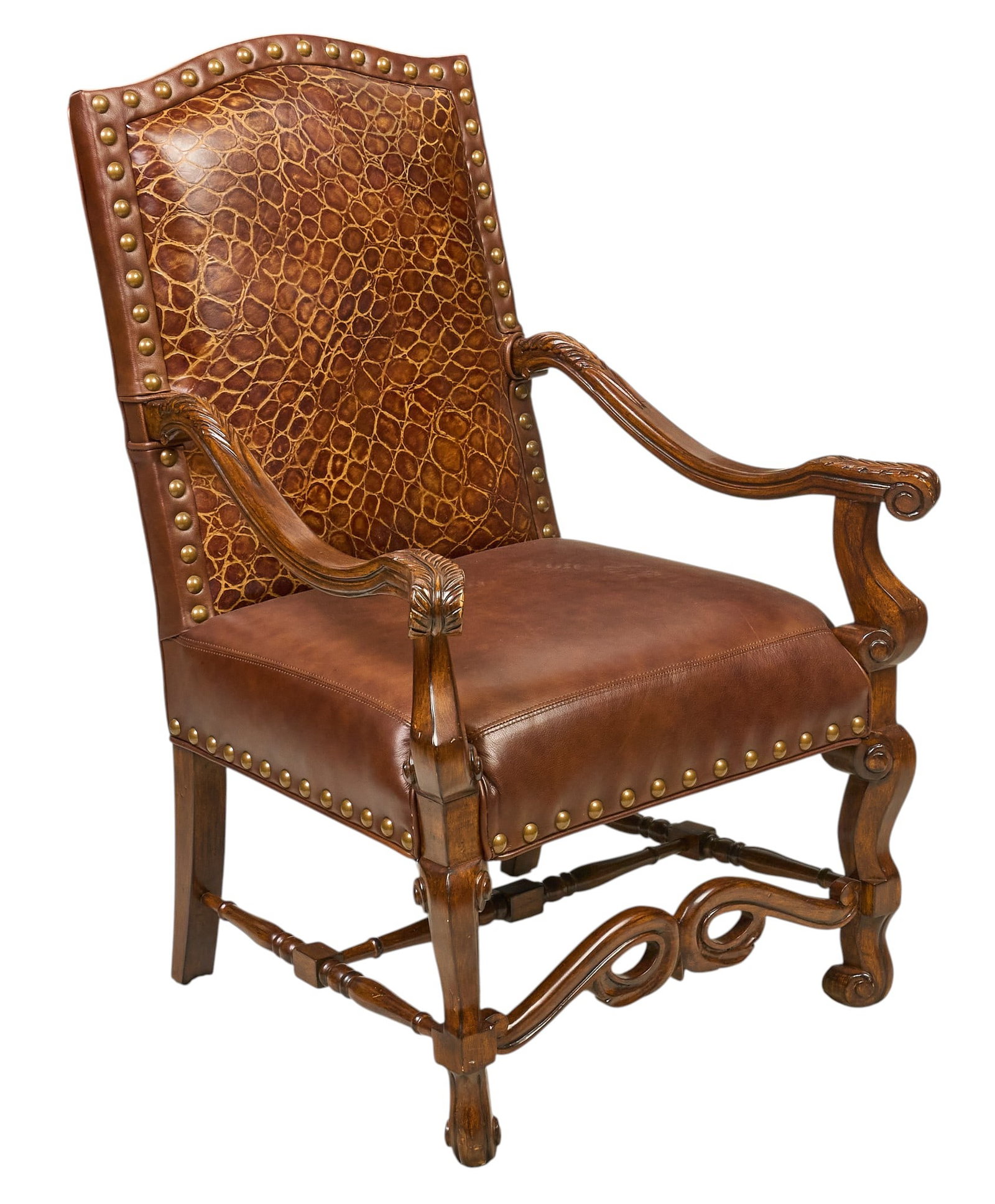 Ornate Crocodile Leather Armchair: Ornate armchair with brown leather upholstery and backrest with crocodile leather, decorated with brass nailhead trim, supported by a carved wooden frame height 43 in. x width 30