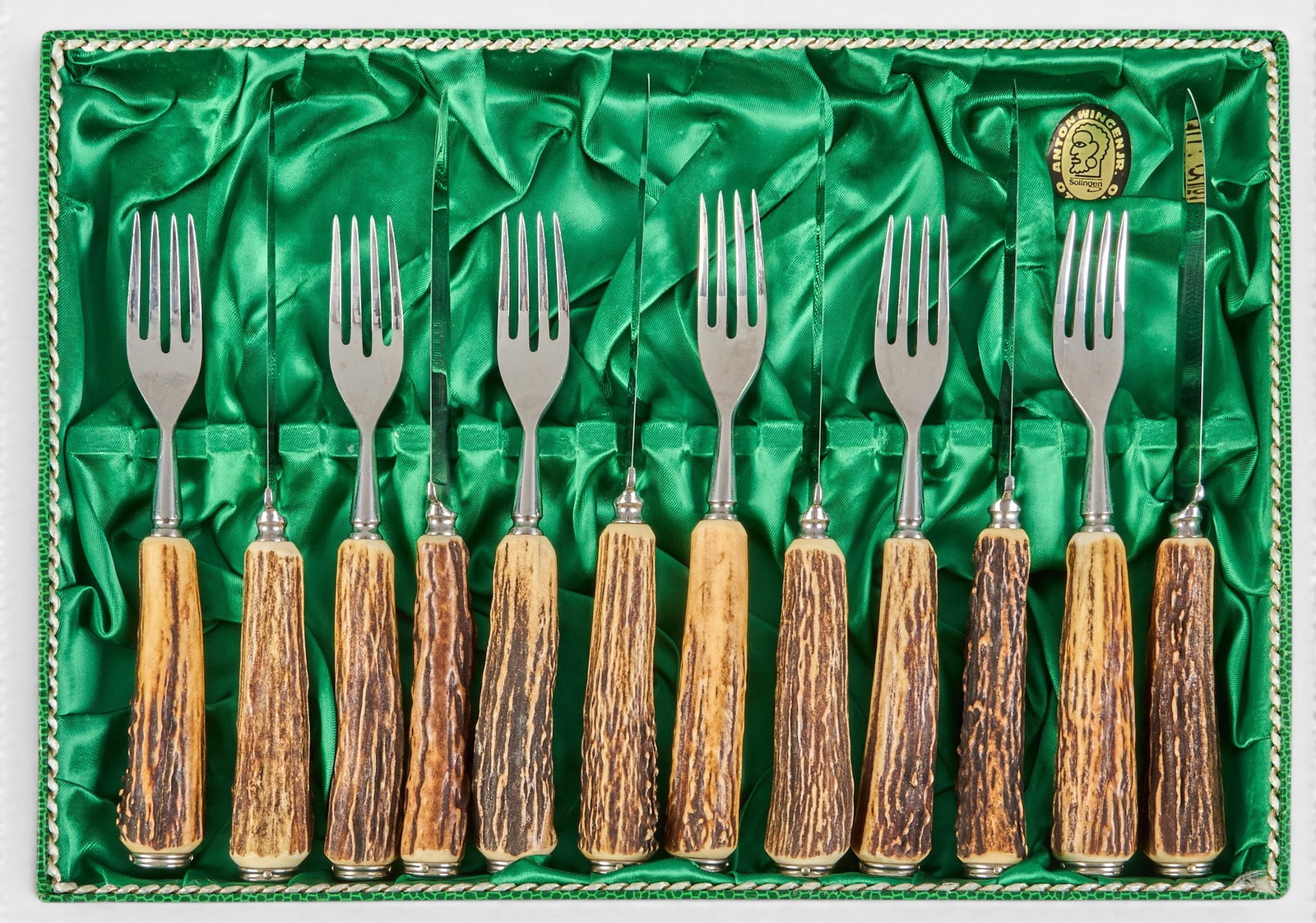 (12) Stag Handle Cutlery Set: Twelve piece stag handle cutlery set with six forks and six knives in fabric lined storage box height 14 in. x width 9.75 in. x depth 1.5 in. / box Provenance: Property from a home in San Antoni