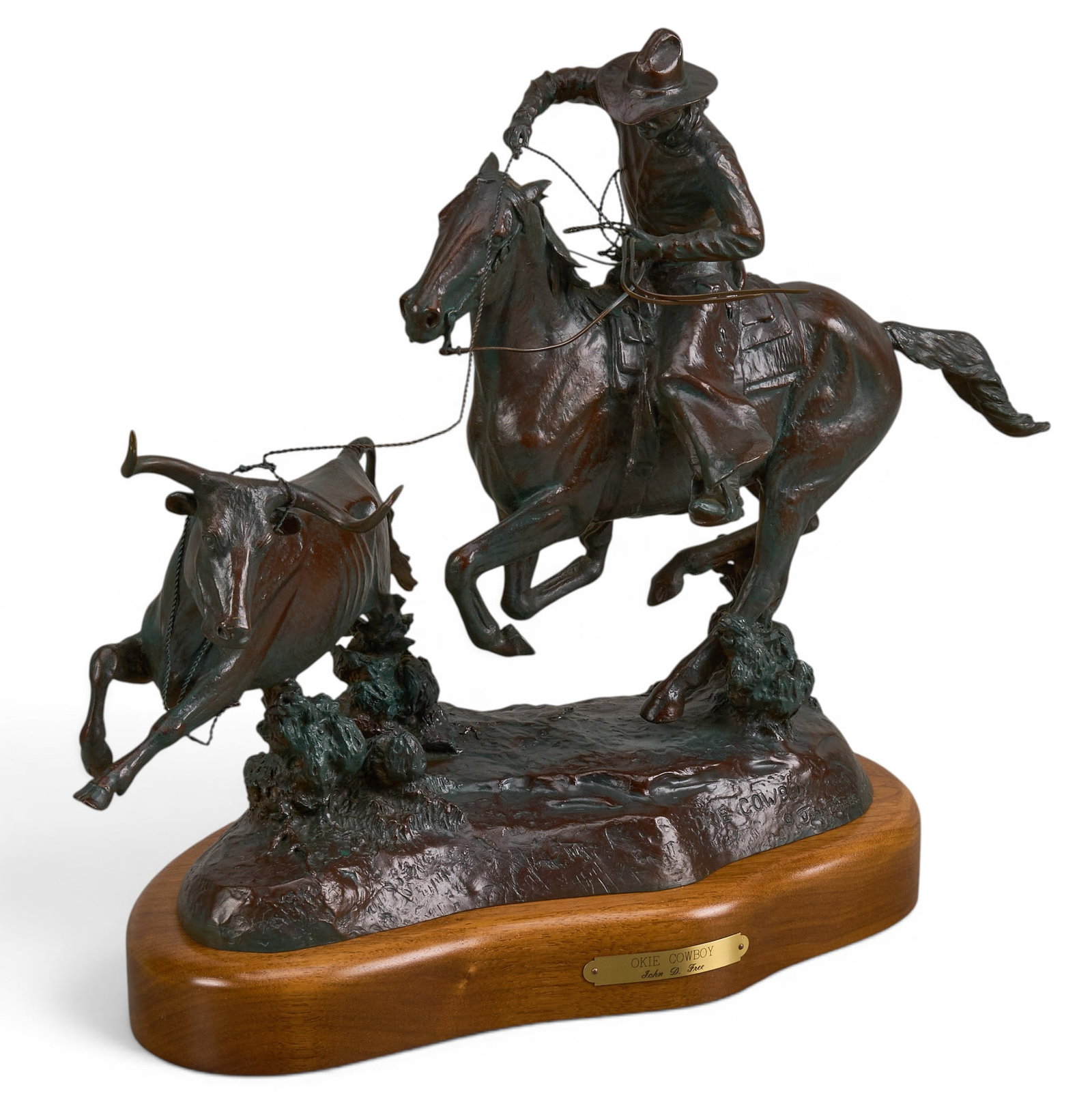 John D. Free, "Okie Cowboy": John D. Free (Oklahoma, 1929-2014), "Okie Cowboy", artist-cast bronze sculpture on wooden base, incised signature, title, and edition number 3/100 height 15.5 in. x width 19.5 in. x dep