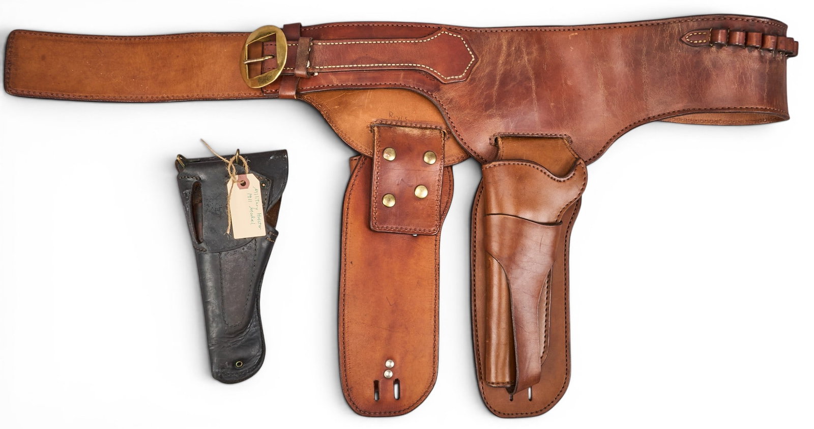 (2) Vintage Leather Holsters: One WWII U.S. Military holster, fits 1911 model in black leather, and one Buscadero double rig, jockstrap style, 7.5" single action colt length 17 in. x width 7 in. x depth 3.5 in. Pro