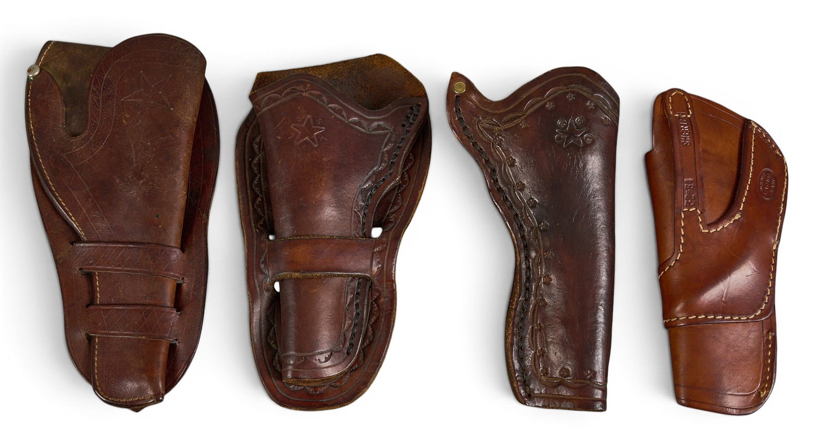 (4) Vintage Leather Holsters: Collection of four vintage leather holsters, including a star-marked double-action pistol revolver holster, two contemporary single-action .22 holsters, and a Buck Meyer clamshell-style holster