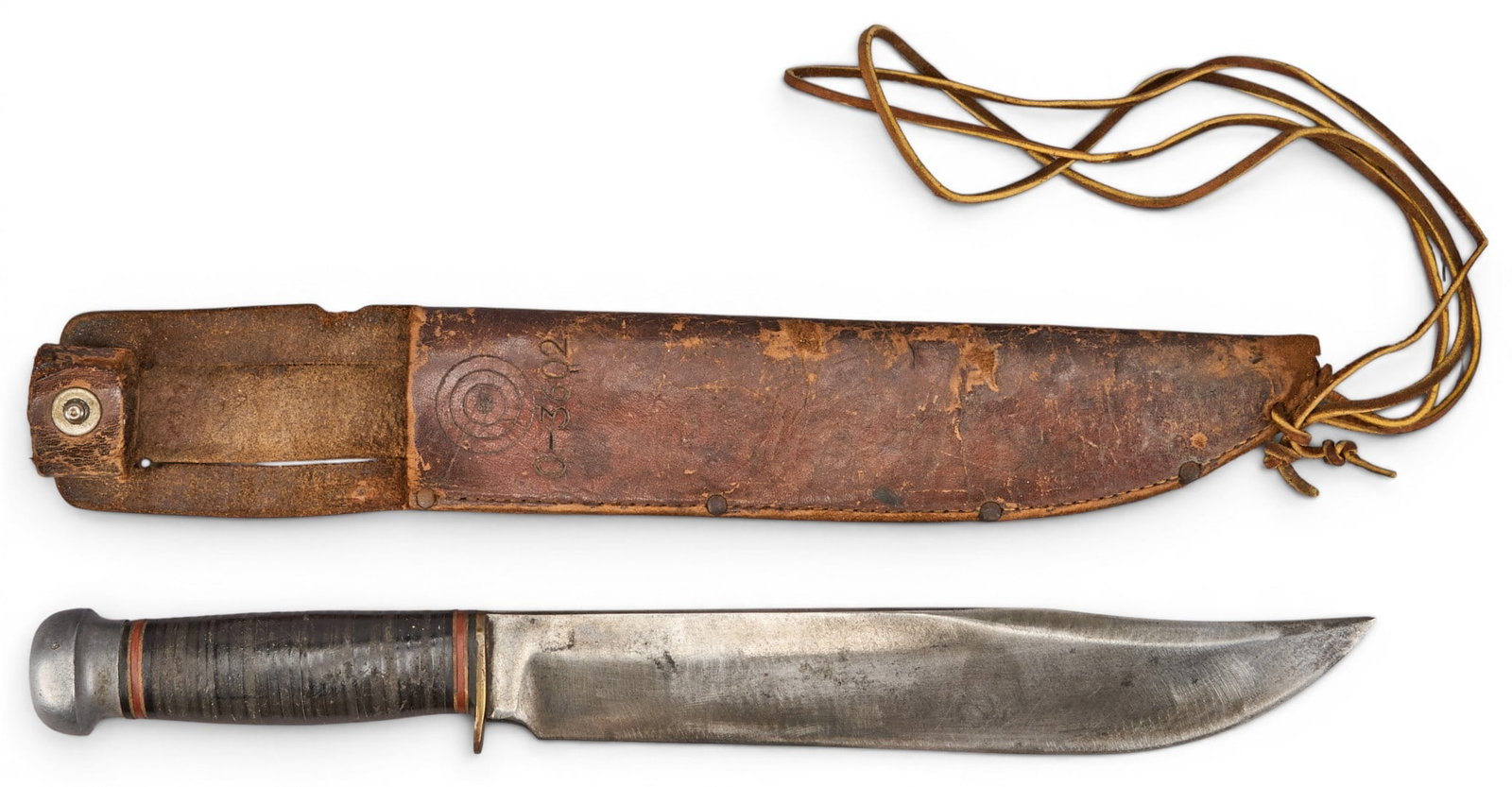 Vintage Marbles Hunting Knife: Vintage Marbles hunting knife with a stacked leather handle and aluminum pommel, and original leather sheath length 15 in. x width 2.5 in. x depth 1.5 in. Provenance: Property from a home in Mat