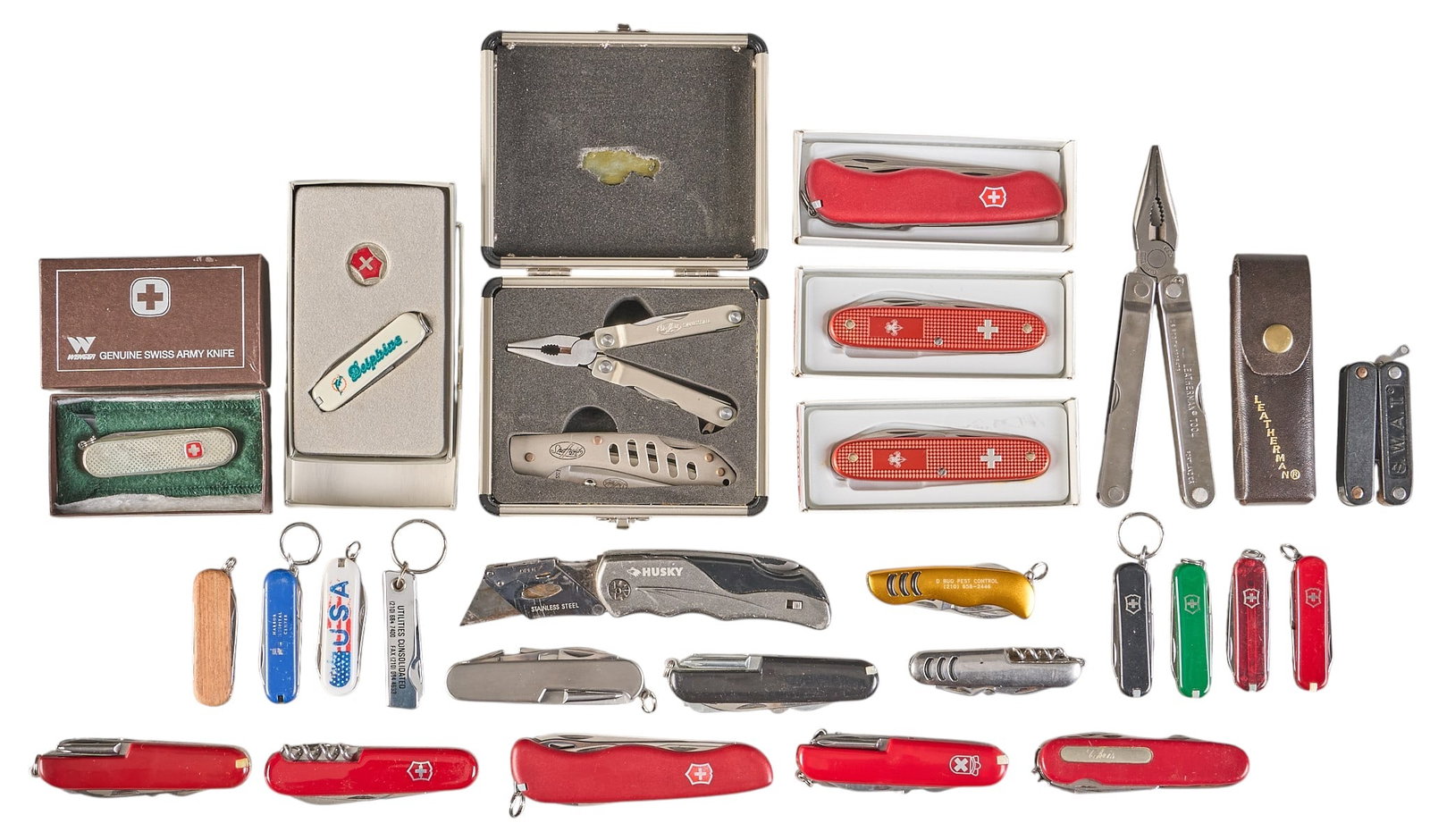 Collection of 24 Misc. Utility & Multi-Tool Knives: 24 mixed utility & multi-tool knives w/ brands including Victorinox Swiss Army, Wenger, Royal Crest, Leatherman, Sheffield, etc. Provenance: A Helotes, Texas collection