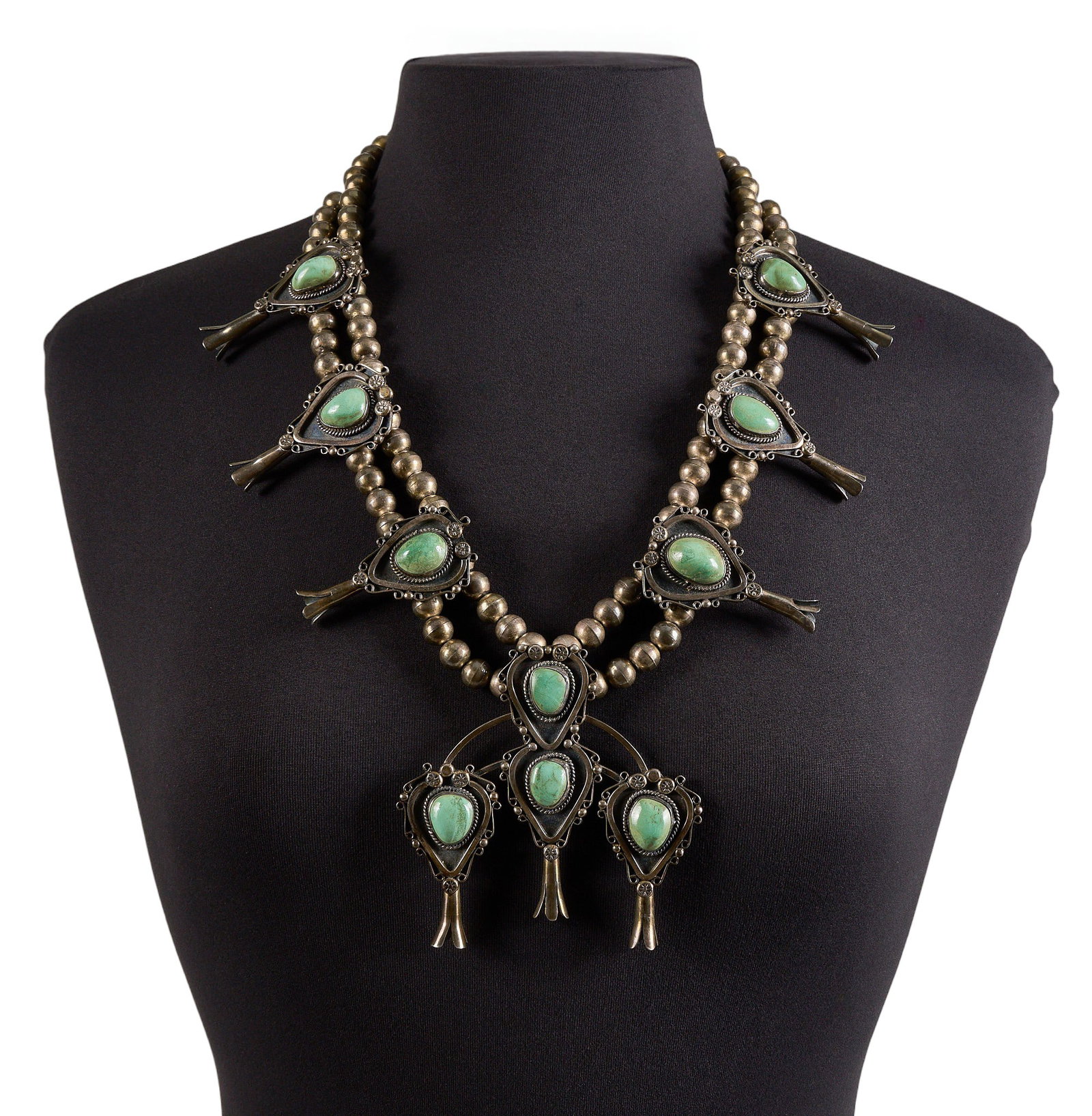 Mexican Sterling Silver & Turquoise Squash Blossom: Mexican sterling silver squash blossom necklace, set with turquoise cabochons throughout, featuring twisted rope motifs and stamped details, with hook and eye closure, marked "Hecho en Mexico 925