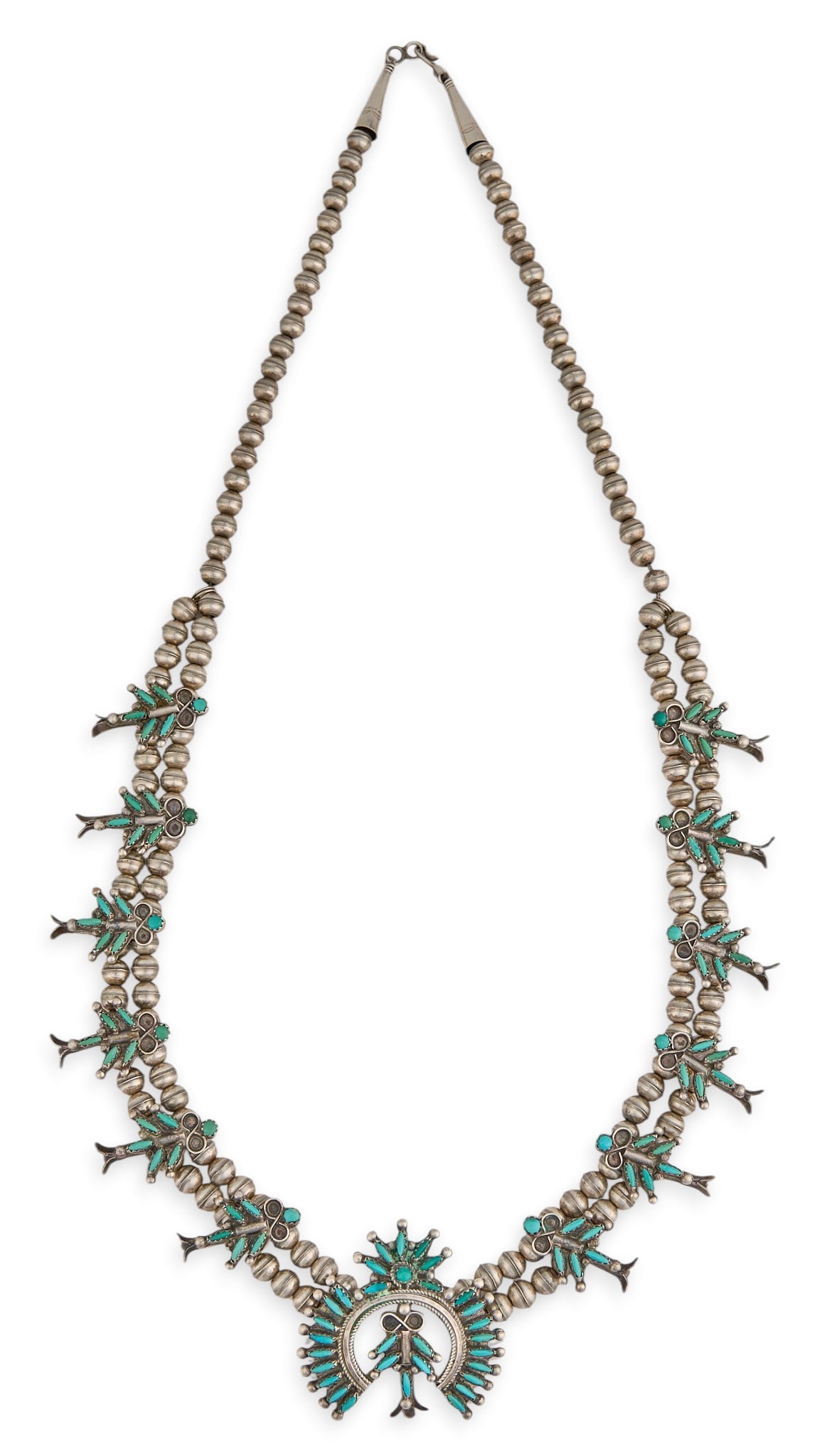 E. Weeka, Sterling & Turquoise Petit Point Squash Blossom: Eleanor Weeka, Zuni sterling silver squash blossom necklace, set with turquoise cabochons in petit point design, with hook and eye closure, signed "E. Weeka Zuni" Length: 27 in. Total w