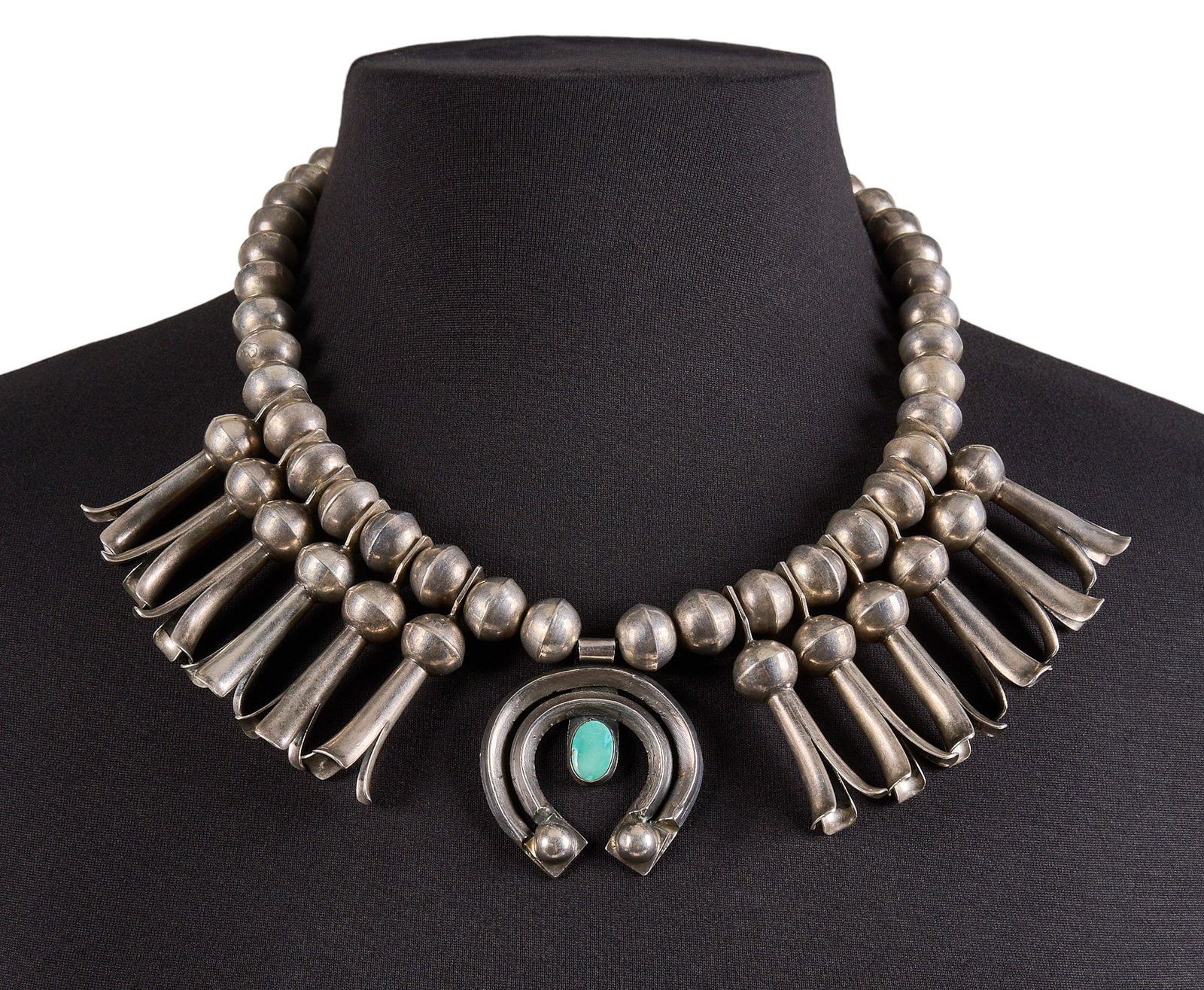 Vintage Sterling & Turquoise Squash Blossom: Vintage sterling silver squash blossom necklace, set with single turquoise cabochon to naja, with hook and eye closure, circa mid-20th century Length: 21 in. Total weight: 181.8 g Provenance: Pro