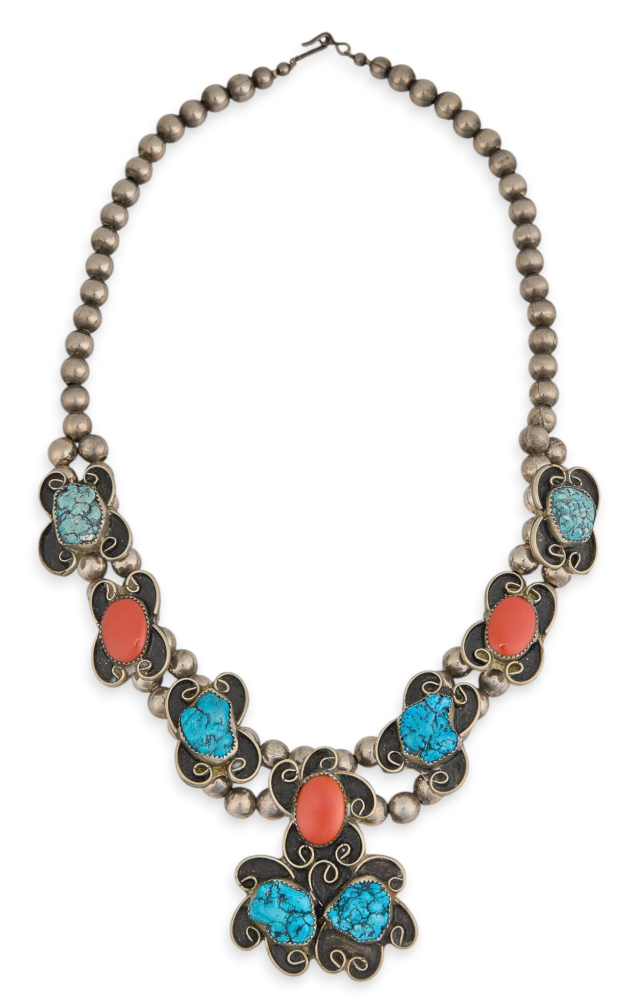 Southwestern Sterling Silver Turquoise & Coral Necklace: Southwestern sterling silver necklace, set with turquoise and coral stones, featuring scrolled details, with hook and eye closure Length: 24 in. Total weight: 141.1 g Provenance: Property from a 