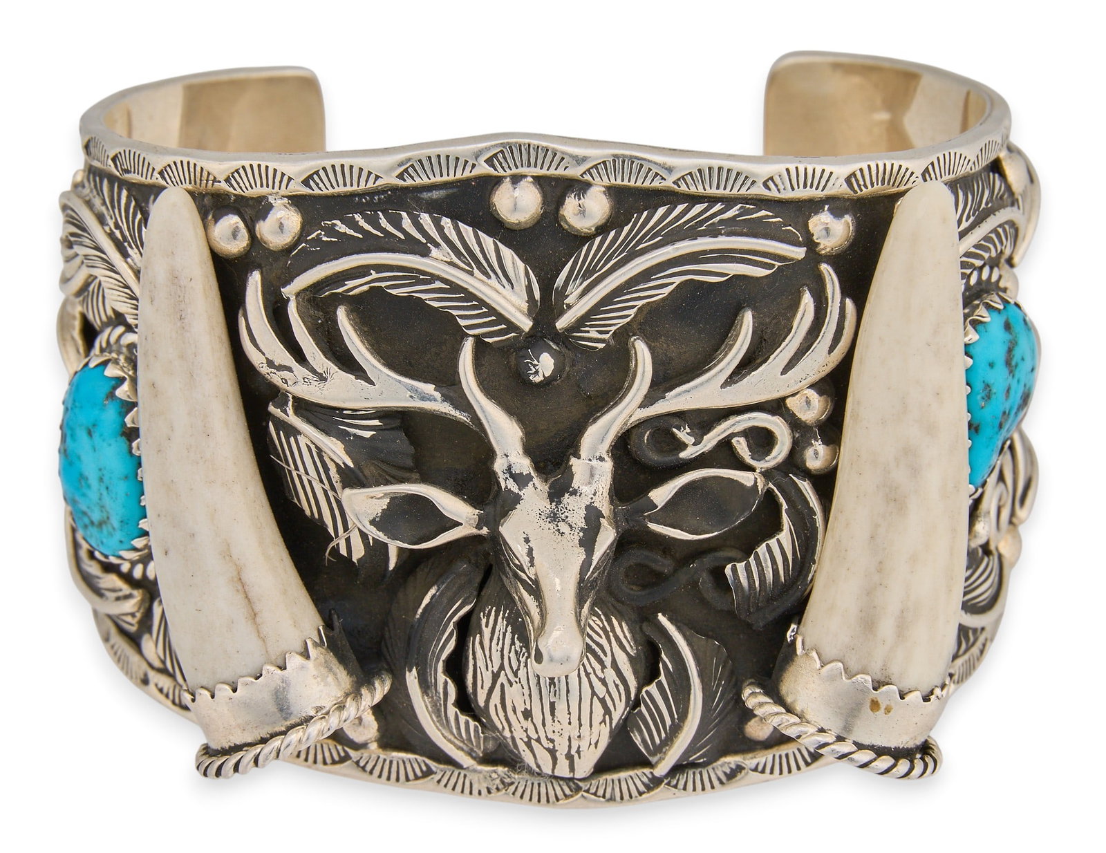 Sterling Silver Turquoise & Stag Horn Cuff: Sterling silver cuff bracelet with central stag motif, flanked by stag horn and turquoise settings, featuring feather and twisted rope motifs, with stamped details throughout, signed "BTN Sterlin