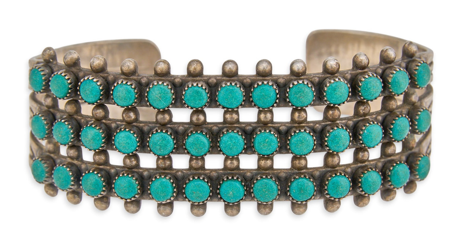 Zuni Petit Point Turquoise Cuff: Zuni sterling silver cuff bracelet, set with three rows of petit point turquoise cabochons, marked "Sterling" Circumference: 6 in. Total weight: 33.7 g