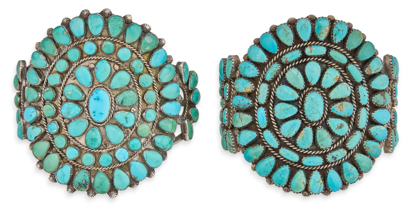 (2) Sterling & Turquoise Cluster Cuffs: Two sterling silver cuff bracelets set with cluster turquoise cabochons and twisted rope details Circumference: 6.5 in. / largest Total weight: 130.29 g Provenance: Property from a home in 
