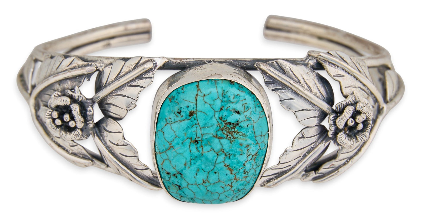 Sterling & Turquoise Floral Motif Cuff: Sterling silver cuff bracelet, set with single turquoise stone, flanked by foliate motifs and stamped details Circumference: 7.25 in. Total weight: 36.4 g