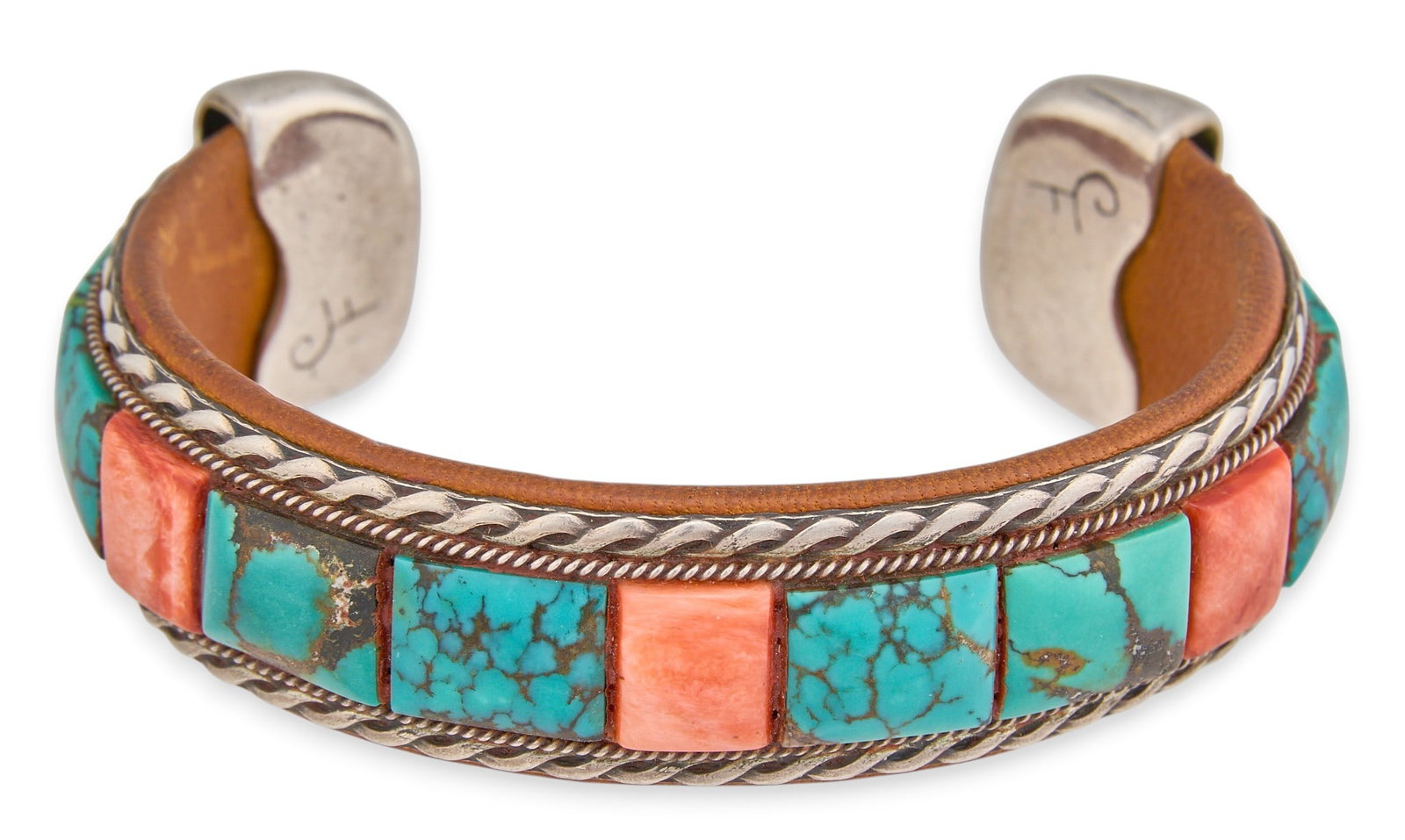Charlie Favour, Sterling Silver Turquoise & Coral Cuff: Charlie Favour (Anglo), sterling silver cuff bracelet, set with square-cut turquoise and coral, featuring twisted rope motif, with brown leather lined interior, signed "CF" Circumference: 6.