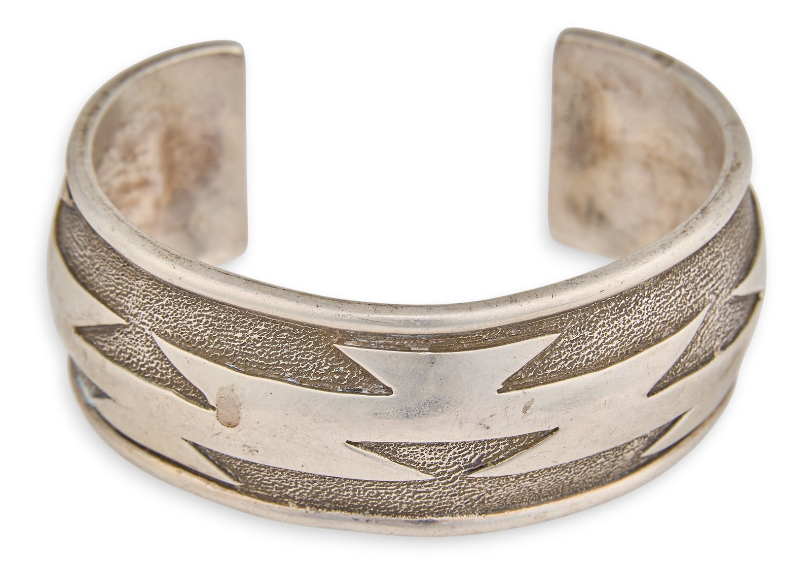 Navajo Sterling Silver Cuff: Navajo sterling silver cuff bracelet with geometric design, signed "Lucky" and marked "Sterling" Circumference: 6.75 in. Total weight: 56.8 g