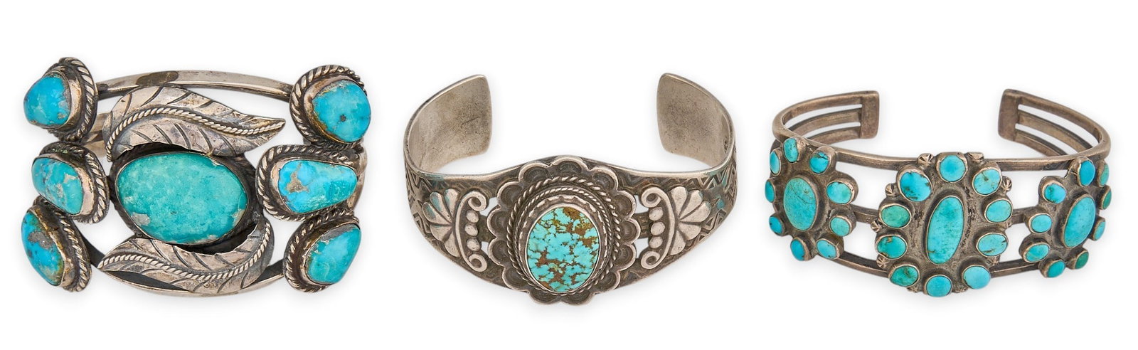 (3) Sterling Silver & Turquoise Cuffs: Three sterling silver cuff bracelets set with turquoise stones, one marked "Maisels Sterling Albuquerque" and another signed "Jigua" Circumference: 6.75 in. / largest Total weight:
