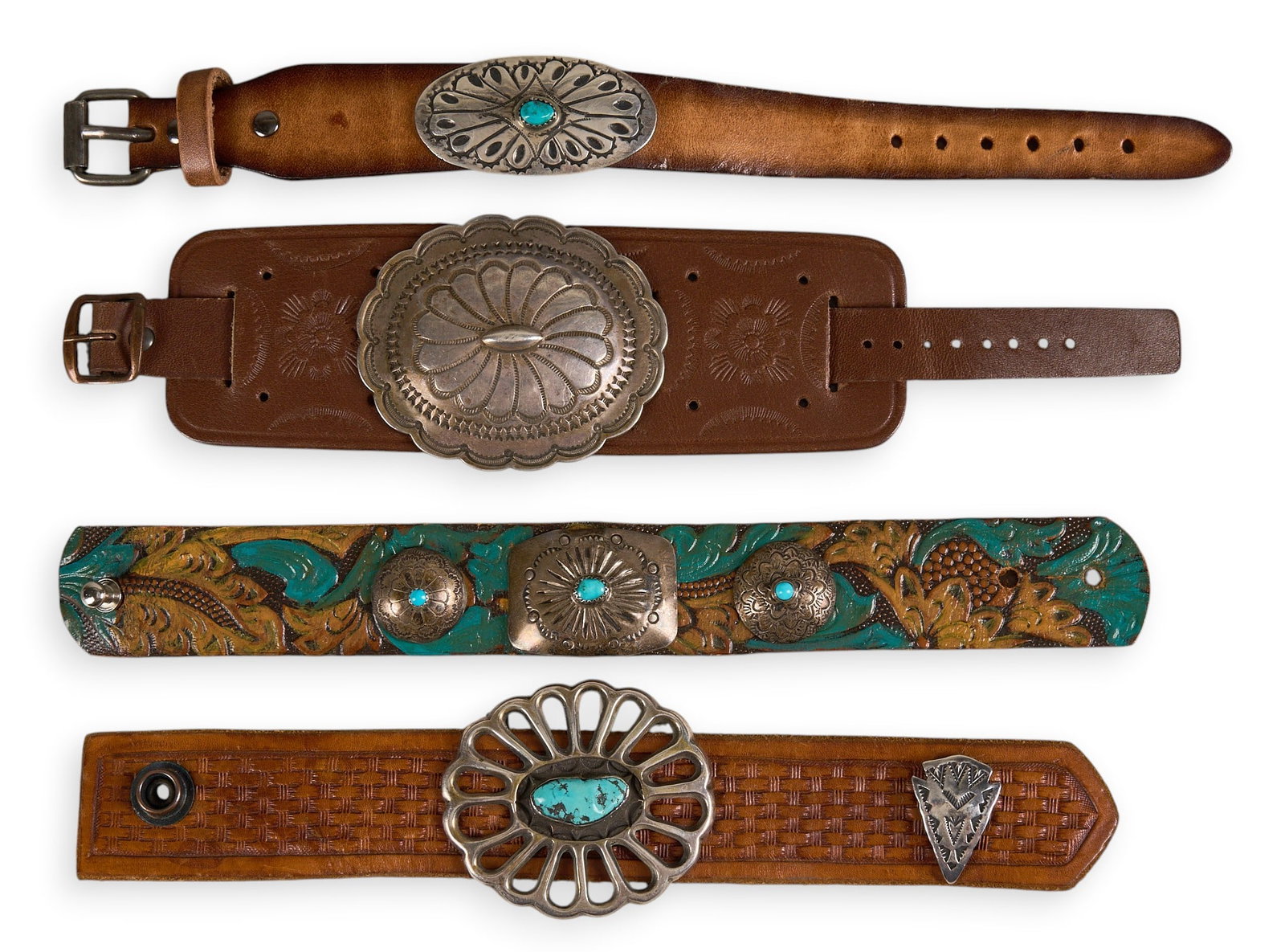 (4) Leather Cuff Bracelets with Conchos: Collection of four leather cuff bracelets, each set with sterling silver conchos, featuring turquoise cabochons and stamped details Length: 9.5 in. / each Total weight: 156.8 g Provenance: Proper