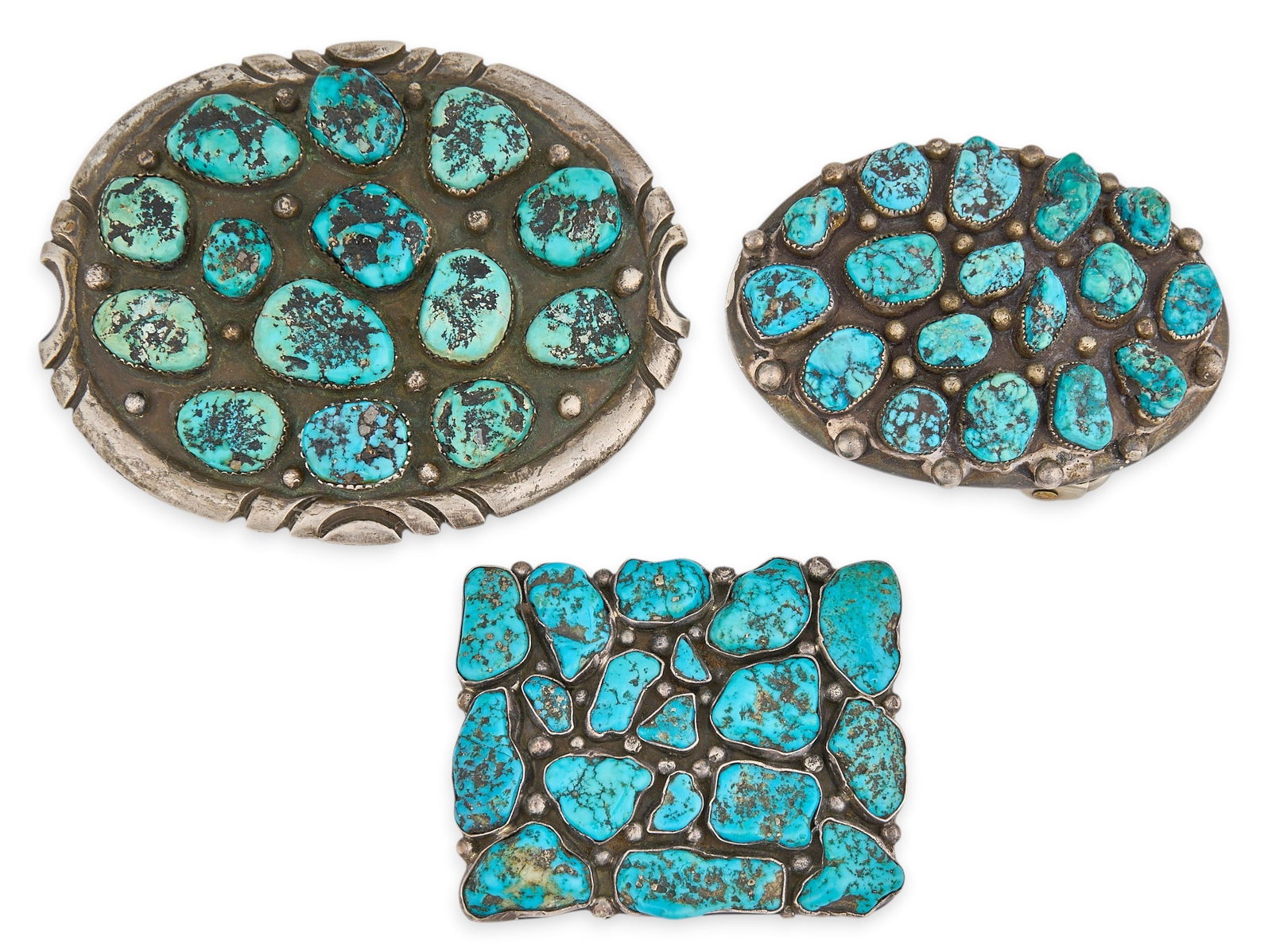(3) Sterling & Turquoise Cluster Buckles: Three sterling silver buckles, each set with turquoise stones in cluster design, all marked to reverse Size: 3.75 in. x 3 in. / largest Total weight: 221.2 g Provenance: Property from a home in S