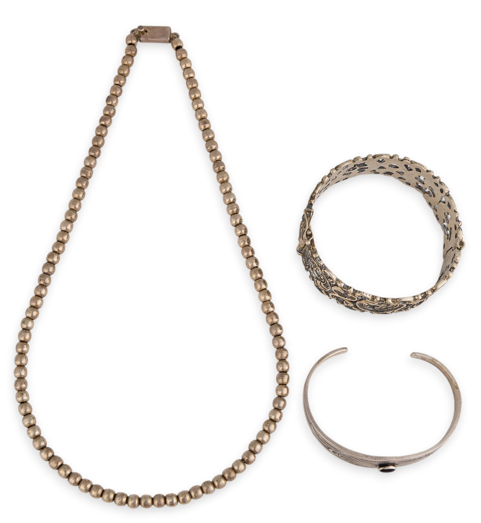 (2) Silver Bracelets and Sterling Beaded Necklace: Mexican sterling silver beaded necklace, marked "Mexico 925", one silver cuff featuring pierced details, marked "835", and one sterling cuff set with single onyx cabochon, mar