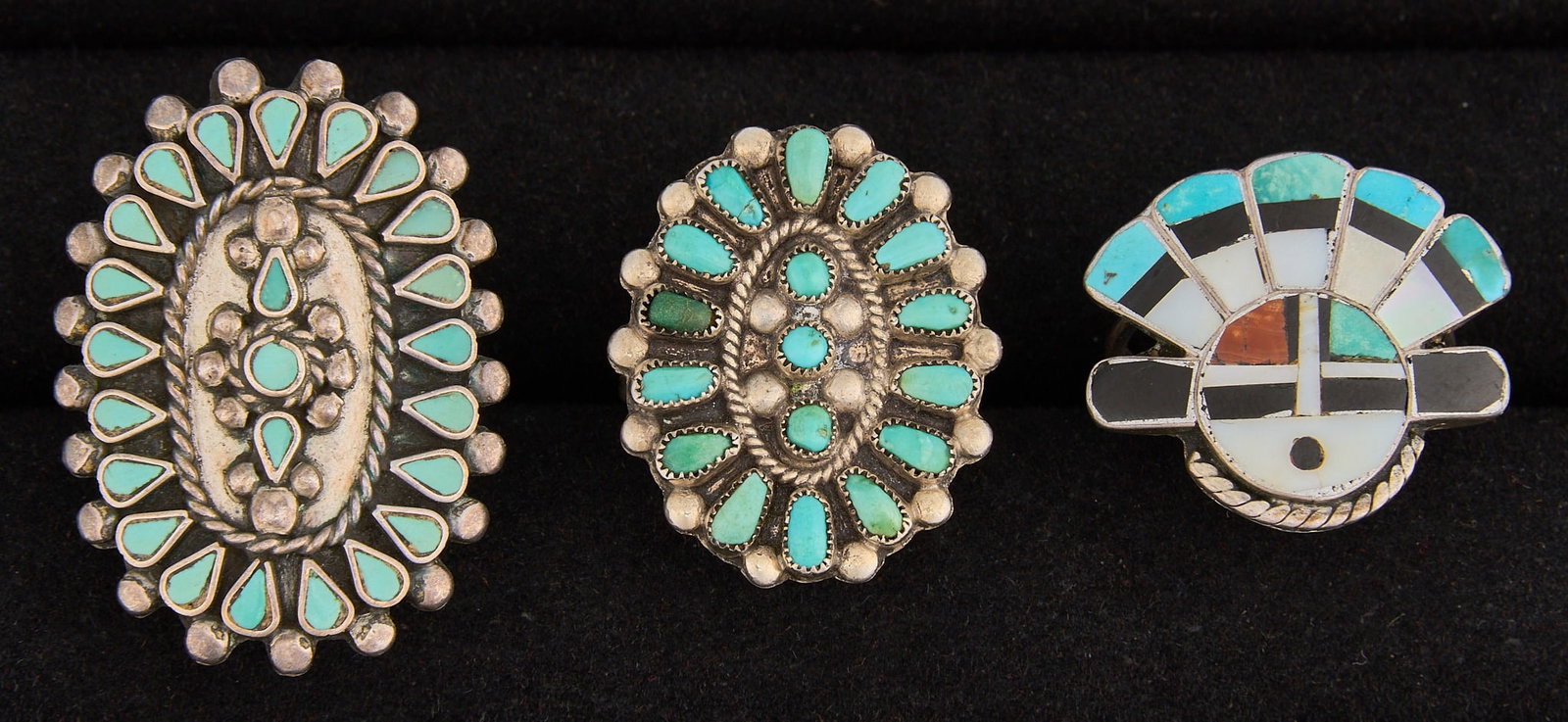 (3) Zuni Style Sterling & Multi-Stone Rings: Three Zuni style sterling silver rings, set with turquoise cabochons and multi-stone inlay, featuring twisted rope motifs Sizes: 6.5-7.75 Total weight: 18.9 g