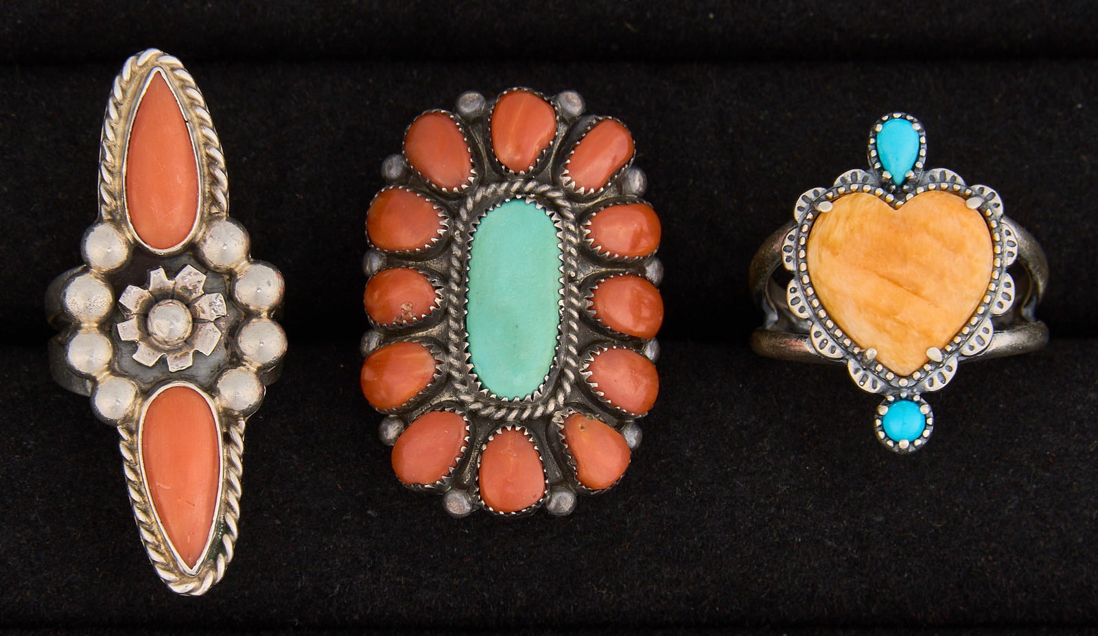 (3) Southwestern Sterling & Multi-Stone Rings: Three Southwestern sterling silver rings, featuring turquoise, coral, and spiny oyster settings, featuring twisted rope motifs and stamped details, marked Sizes: 5-10 Total weight: 27.3 g
