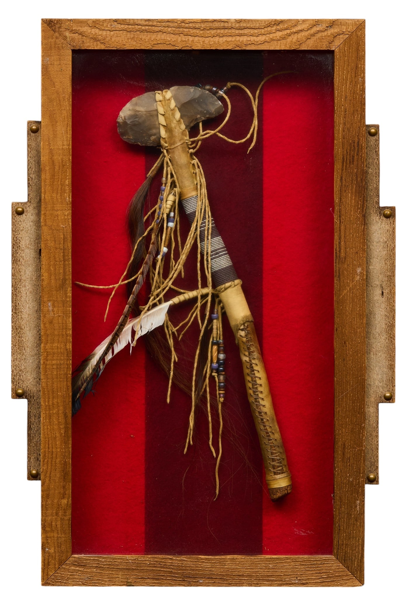 Framed Native American Style Tomahawk: Framed Native American style tomahawk decorated with feathers and intricate beadwork, presented in a shadow box frame, signed on back "Walking Bear" height 28 in. x width 19 in. x depth