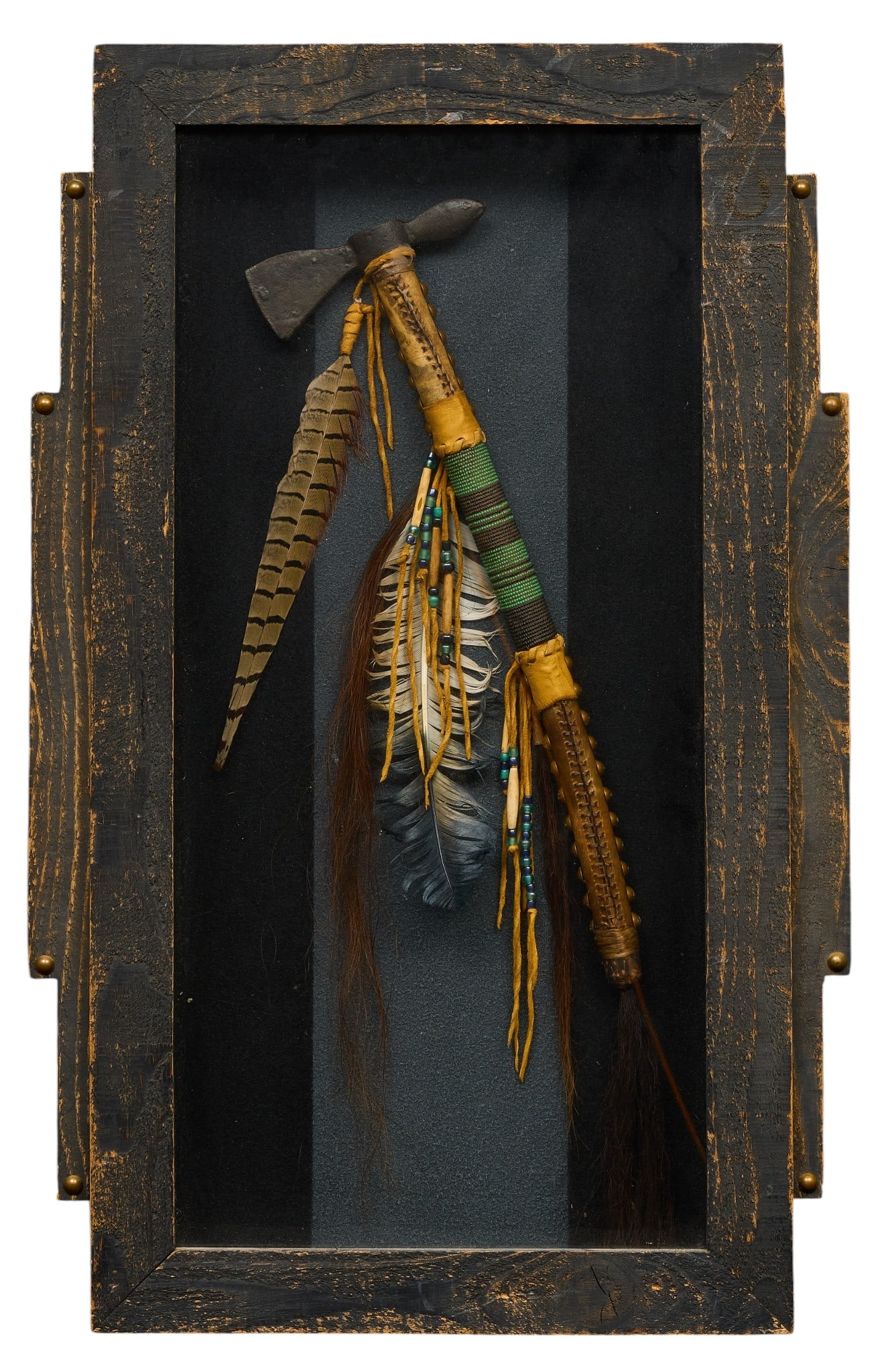 Framed Native American Style Tomahawk: Framed Native American style tomahawk decorated with feathers and intricate beadwork, presented in a shadow box frame, signed on back "Walking Bear" height 30 in. x width 19 in. x depth 3