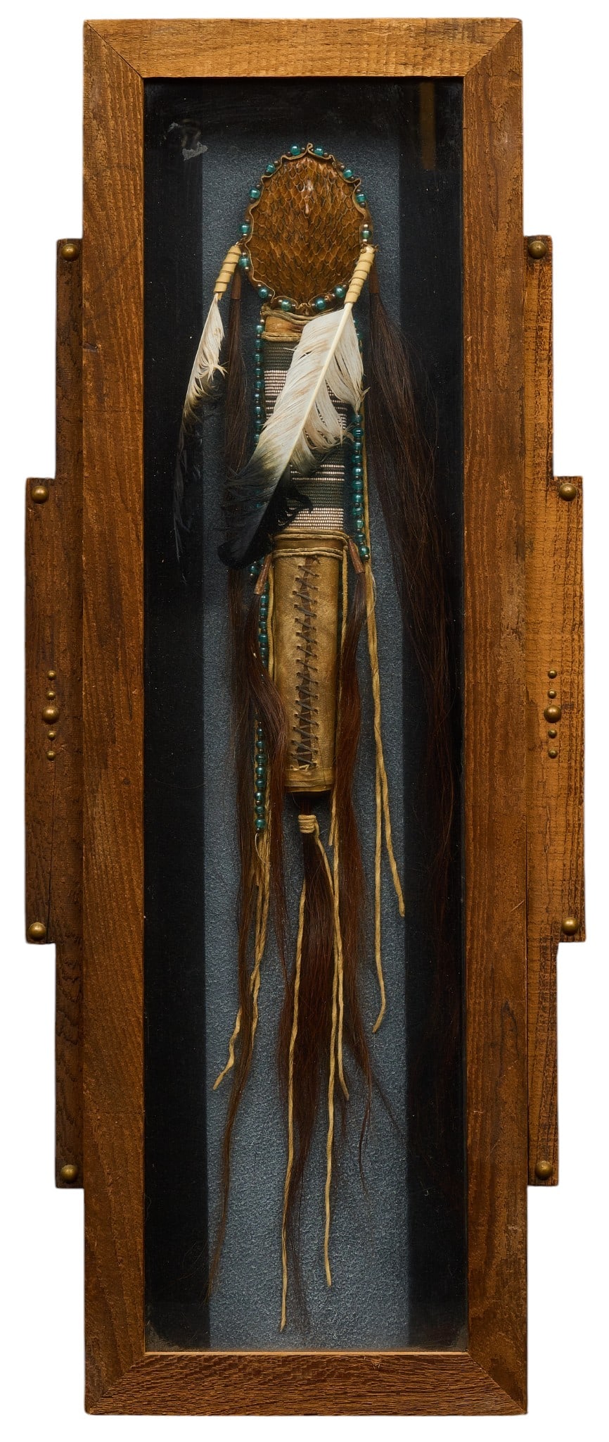 Framed Native American Ceremonial Staff: Framed Native American style tomahawk decorated with snake skin, feathers and intricate beadwork, presented in a shadow box frame, signed on back "Walking Bear" height 35 in. x width