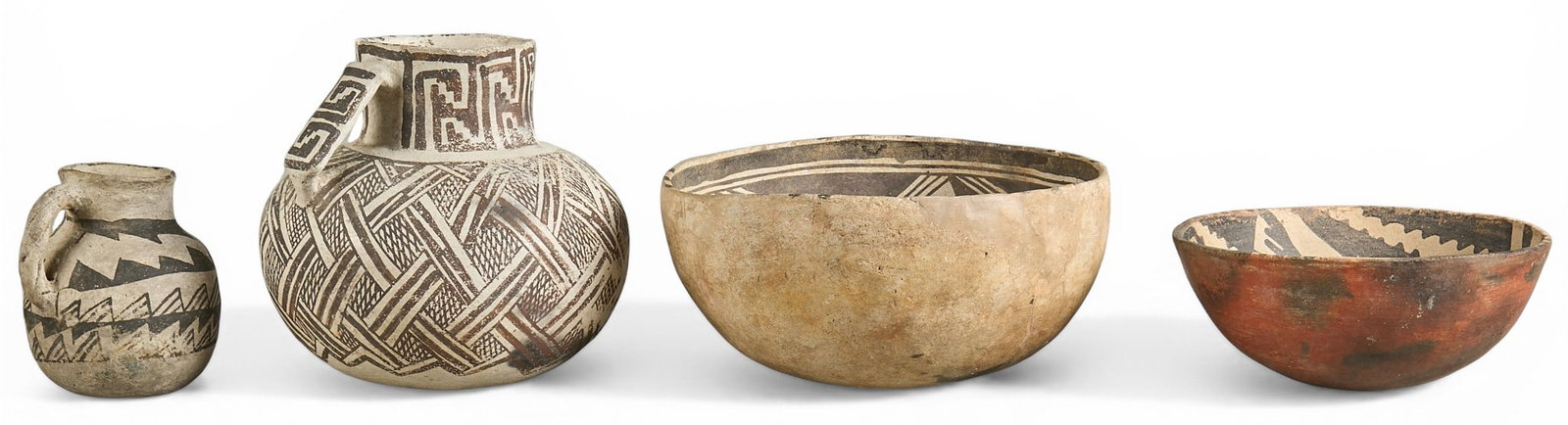 (4) Puebloan Pottery: Collection of four antique Puebloan style pottery pieces with two bowls, and two pitchers with hand-painted decoration height 3.5 in. x width 8 in. x depth 8 in. / largest Provenance: Property fr