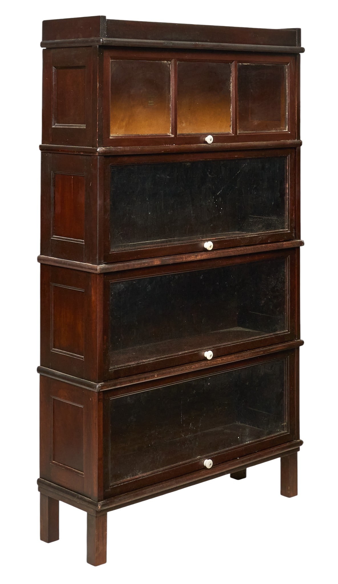 Stacking Bookcase: Four-tier stacking barrister bookcase with glass-front doors, supported on block legs height 61.5 in. x width 34.5 in. x depth 12 in. Provenance: Property from a home in San Antonio, Texas
