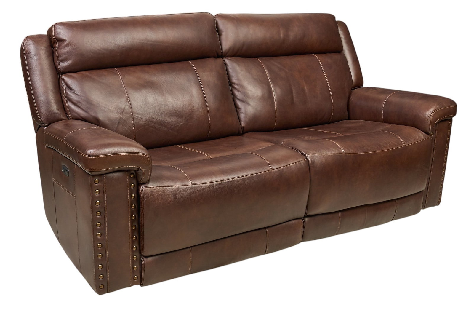 Brown Leather Reclining Sofa: Brown leather reclining sofa, with studded accents on the arms and USB charging ports height 39 in. x width 84 in. x depth 37 in. Provenance: Property from the Estate of Robert A.