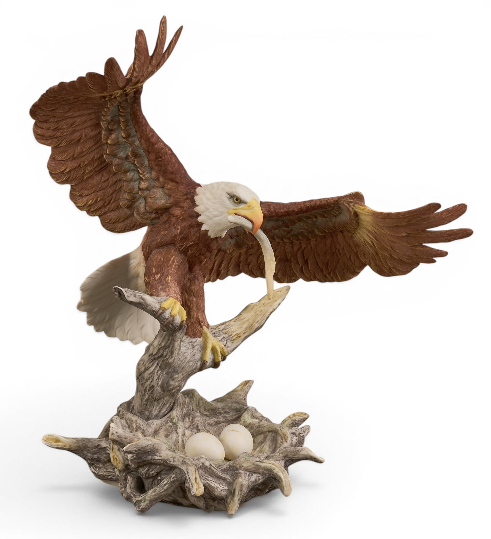 Boehm Porcelain Eagle Sculpture: Boehm porcelain eagle sculpture, depicting an eagle above a nest with a fish in mouth, edition number 112, marked to underside height 15in. x width 12 in. x depth 8 in. Provenance: Property from a