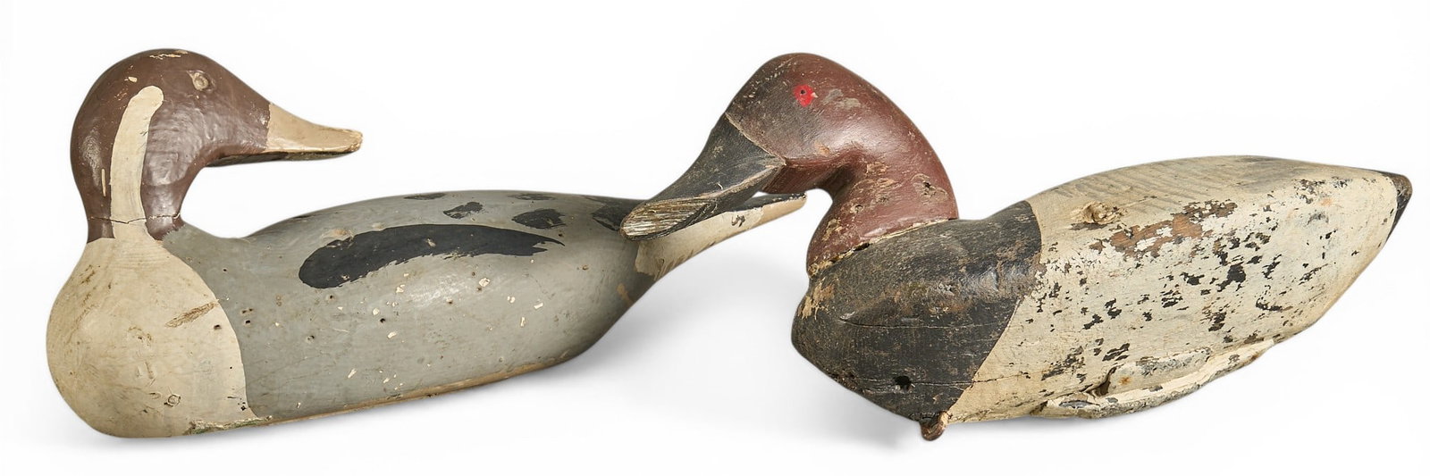 (2) Vintage Duck Decoys: Pair of vintage wooden duck decoys, one with a grey body and black markings, the other with a white body and black markings height 8 in. x width 15 in. x depth 6 in. / largest Provenance: Property fro