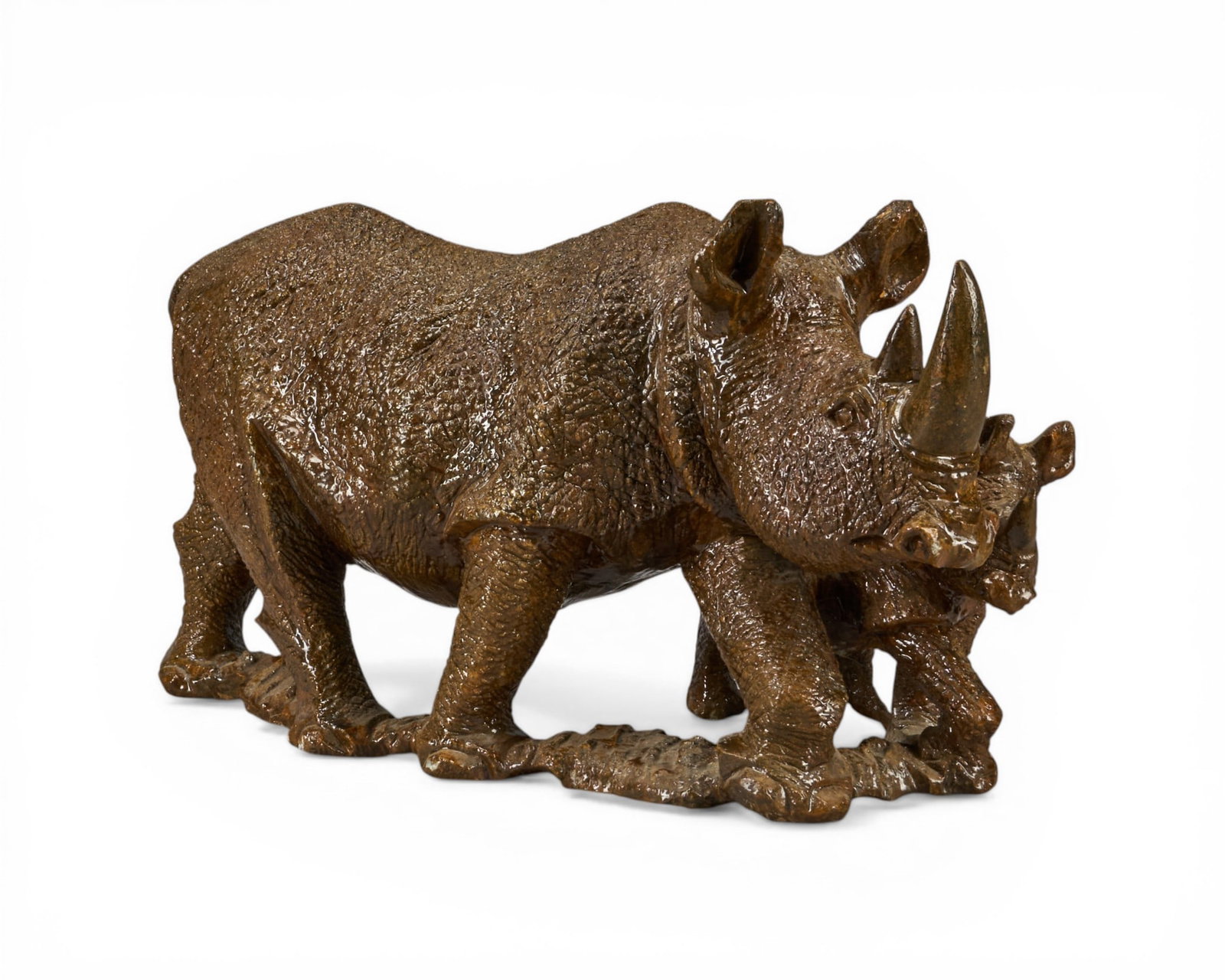 Stone Rhino Sculpture: Heavy, lacquered stone sculpture depicting mother and calf rhino height 11 in. x width 19 in. x depth 9 in. Provenance: Property from a home in Edna, Texas