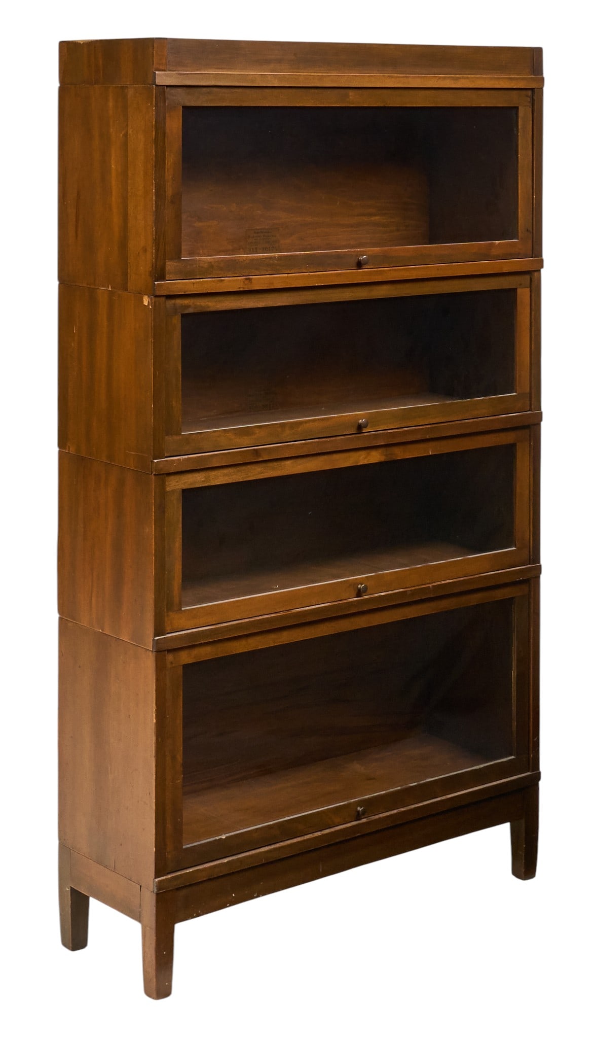 Stacking Bookcase: Four-tier stacking barrister bookcase with glass-front doors, supported on block legs height 61 in. x width 34 in. x depth 12 in. Provenance: Property from a home in Castroville, Texas 