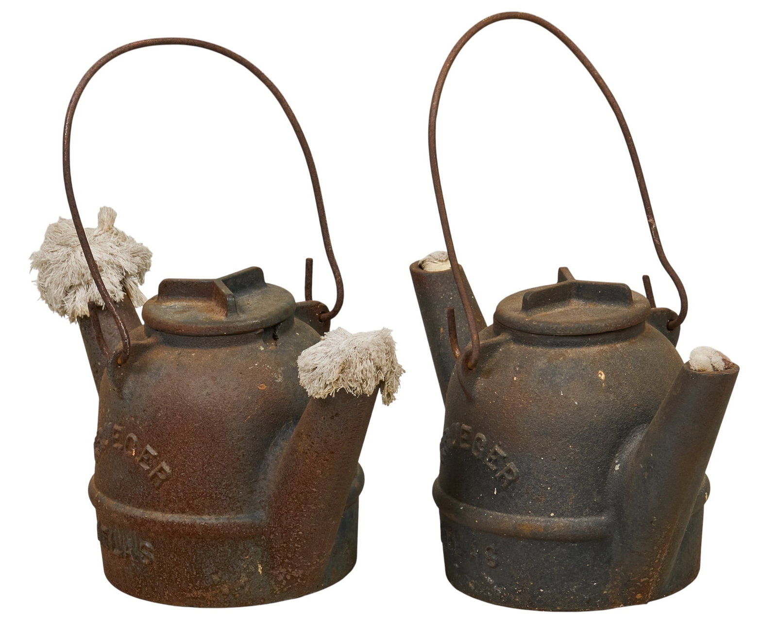 Pair of 1920s Cast Iron Oil Cans: Two antique cast iron oil cans, circa 1920s height 14 in. x width 6 in. x depth 13 in. / each Provenance: Property from a home in San Antonio, Texas 