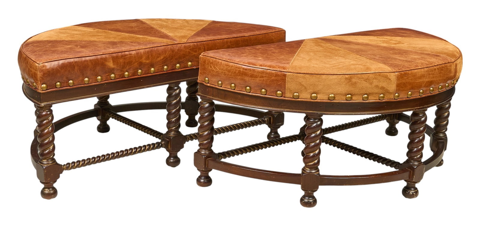 Pair of Vintage Leather Ottomans: Pair of demilune leather ottomans featuring leather upholstery, accented with brass nailhead trim, raised on stretchered barley twist legs ending in bun feet height 21 in. x width 47 in. x depth