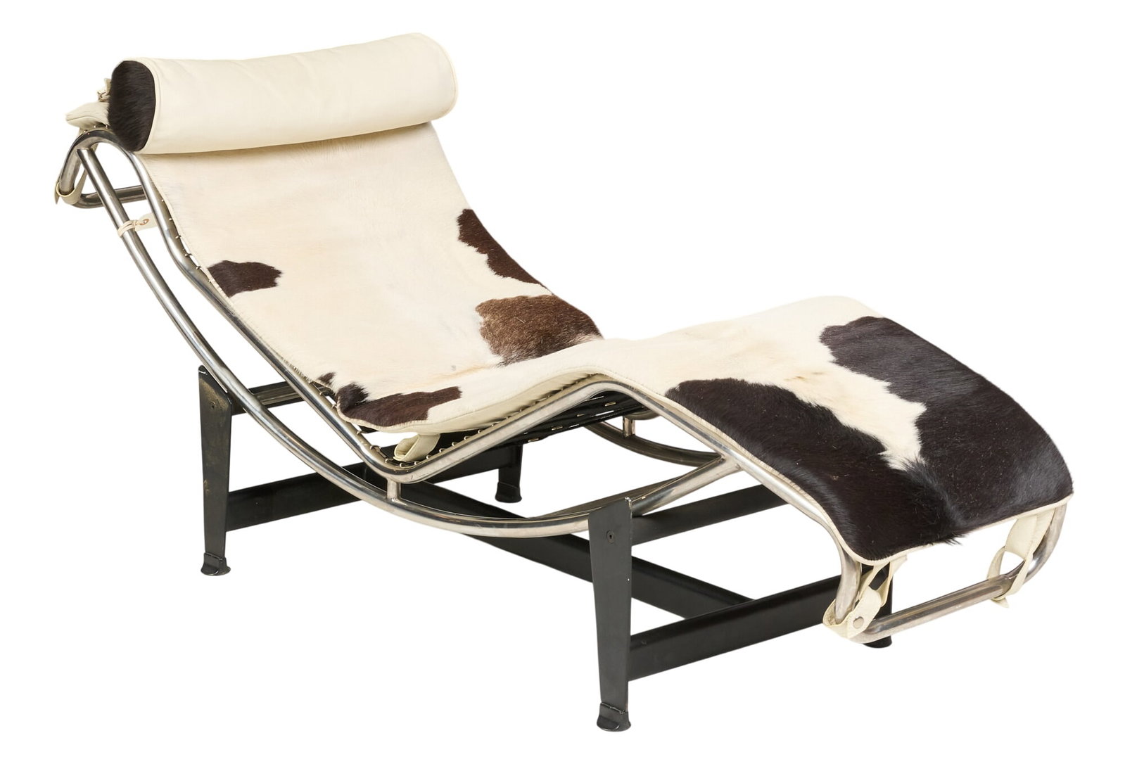 After Le Corbusier, Chaise Lounge Chair: Mid-century lounge chair, chrome frame with cowhide upholstery, and black leather pillow, supported on black metal base, after an original 1928 design by Charles-Édouard Jeanneret