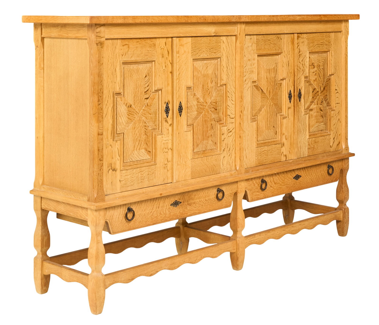 Henning Kjaernulf, Mid-Century Credenza: Henning Kjaernulf (Denmark) oak mid-century credenza with four cabinet doors, shelved interior, and bottom drawers, supported on shaped legs height 49 in. x width 77.5 in. x depth 19.5 in. 