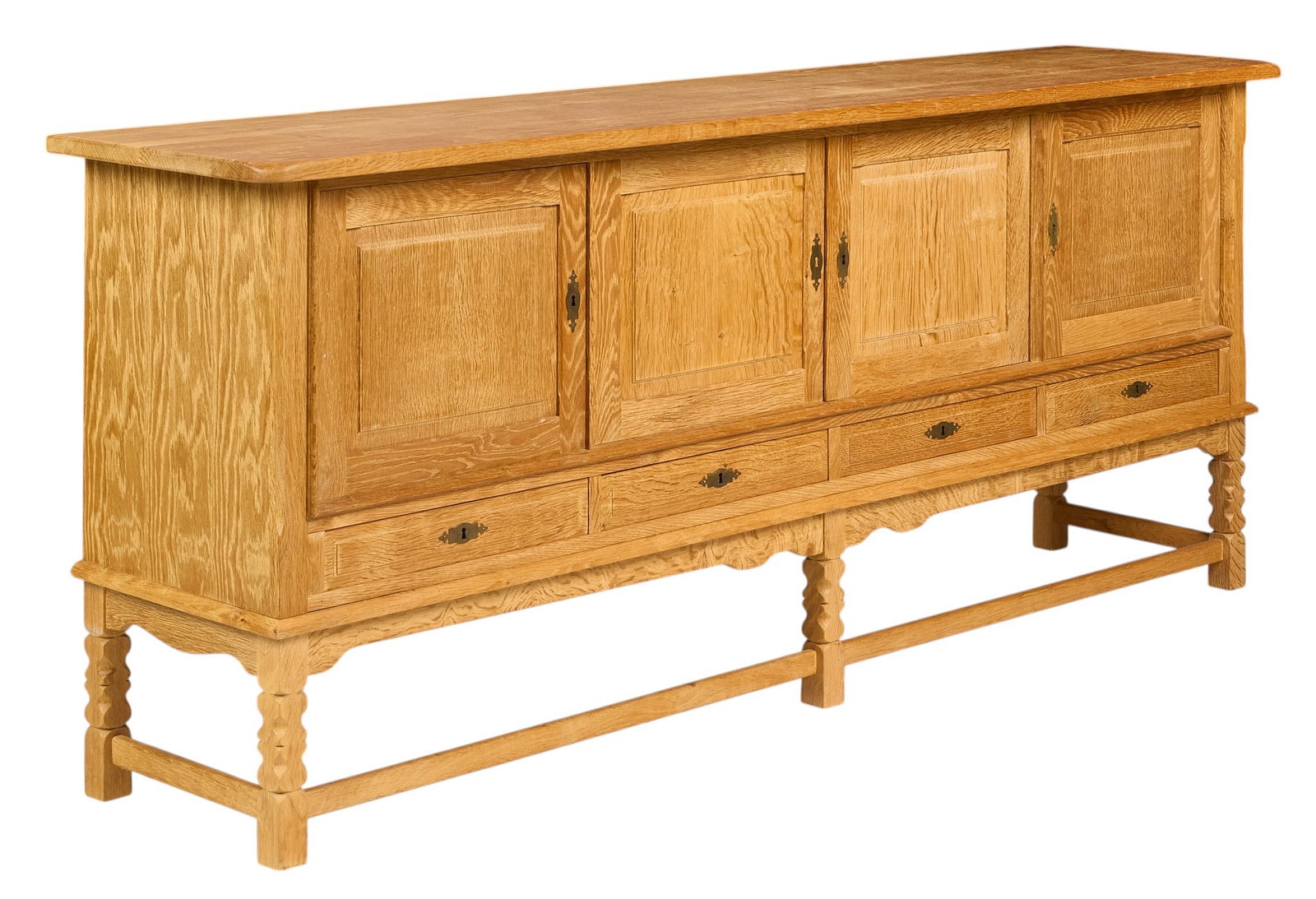 Henning Kjaernulf, Mid-Century Credenza: Henning Kjaernulf (Denmark) mid-century credenza with four cabinet doors, interior shelving, and bottom drawers, supported on faceted block legs, with key height 36 in. x width 88.5 in. x depth