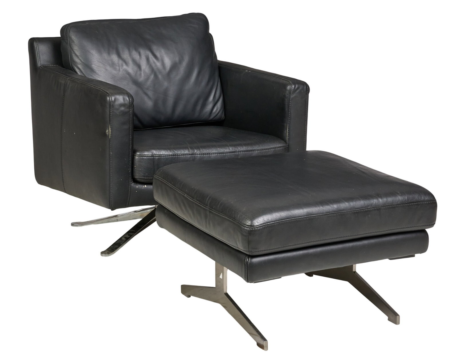 Leather Armchair with Ottoman: Armchair and matching ottoman by Kelvin Giormani, featuring black leather upholstery and metal bases, marked by maker height 30 in. x width 34 in. x depth 36 in. / chair