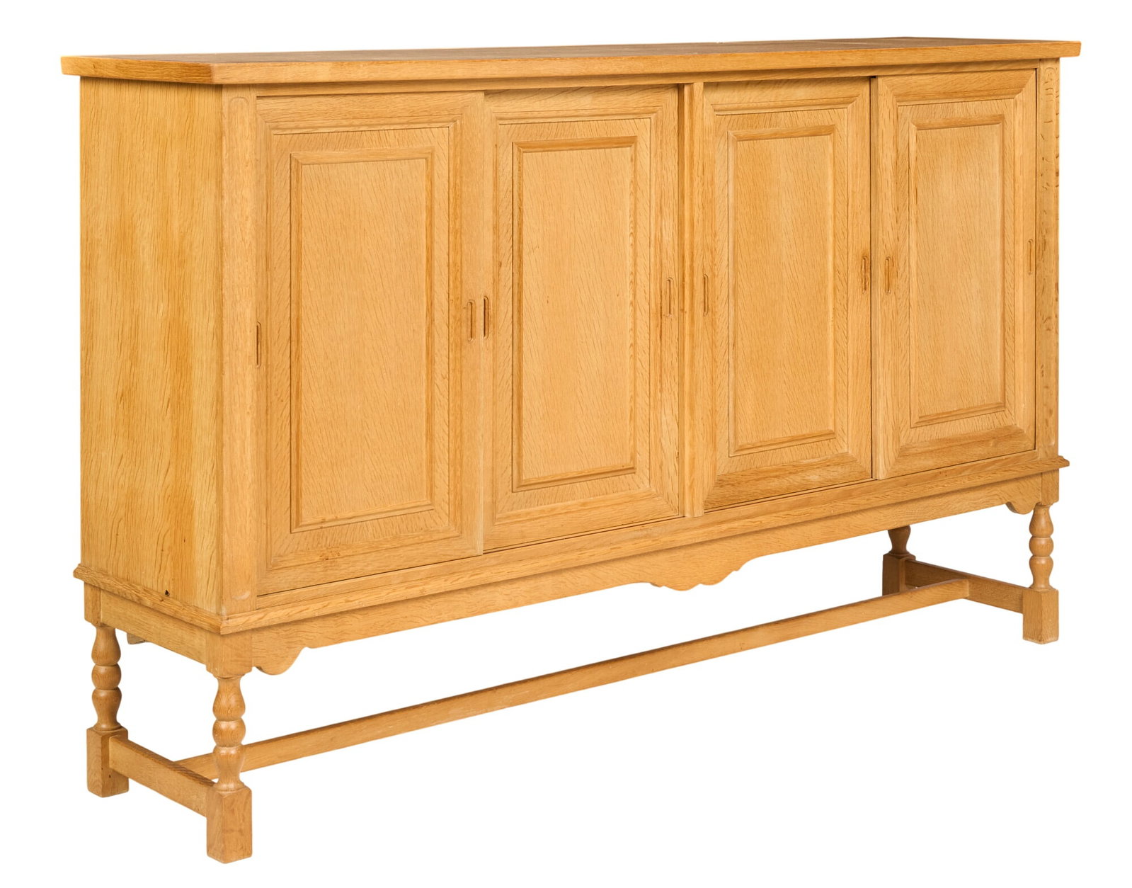 Henning Kjaernulf, Mid-Century Credenza: Henning Kjaernulf (Denmark) oak mid-century credenza with four cabinet doors, and shelved storage, supported on turned legs height 47 in. x width 79 in. x depth 18.5 in. 