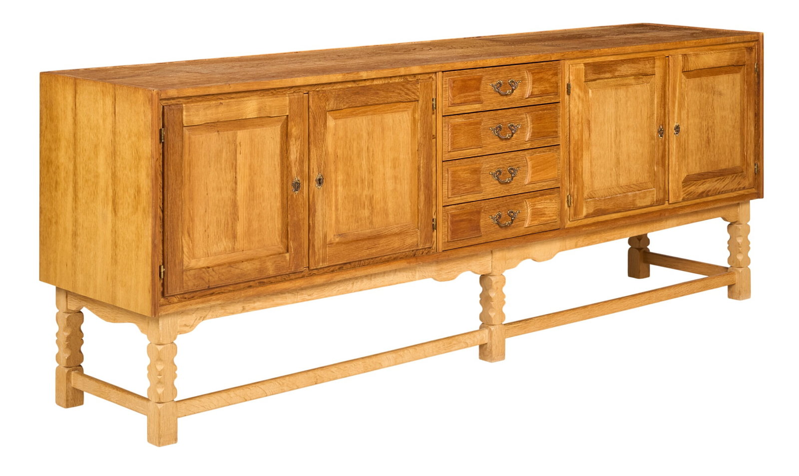 Henning Kjaernulf, Mid-Century Credenza: Henning Kjaernulf (Denmark) oak mid-century credenza with cabinet and drawer storage, supported on faceted block legs height 31.5 in. x width 86.5 in. x depth 18.5 in. 