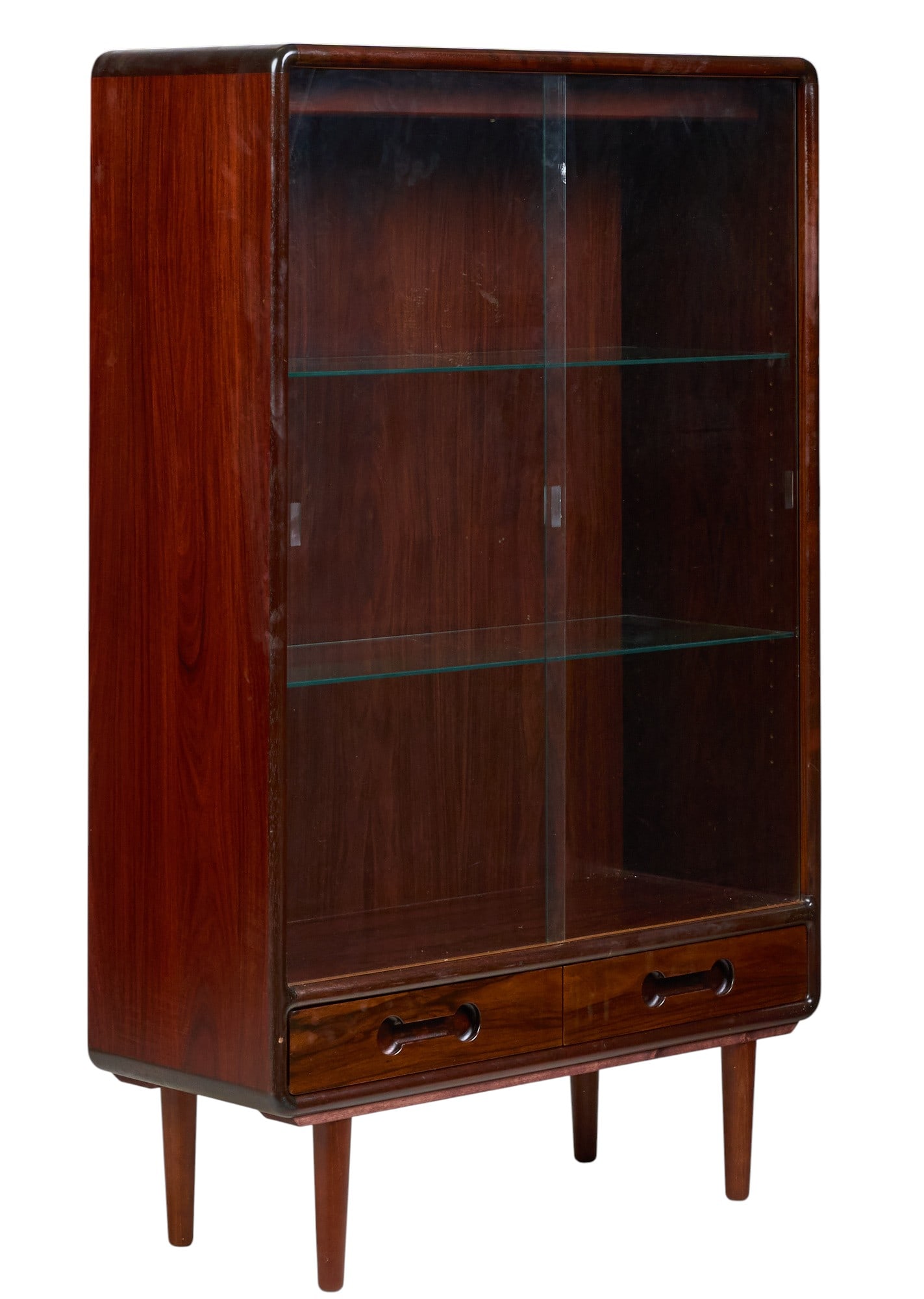 Danish Mid-Century Bookcase: Danish mid-century bookcase with sliding glass doors, and glass shelves above two bottom drawers, supported on pin legs height 56.5 in. x width 35 in. x depth 14 in. 