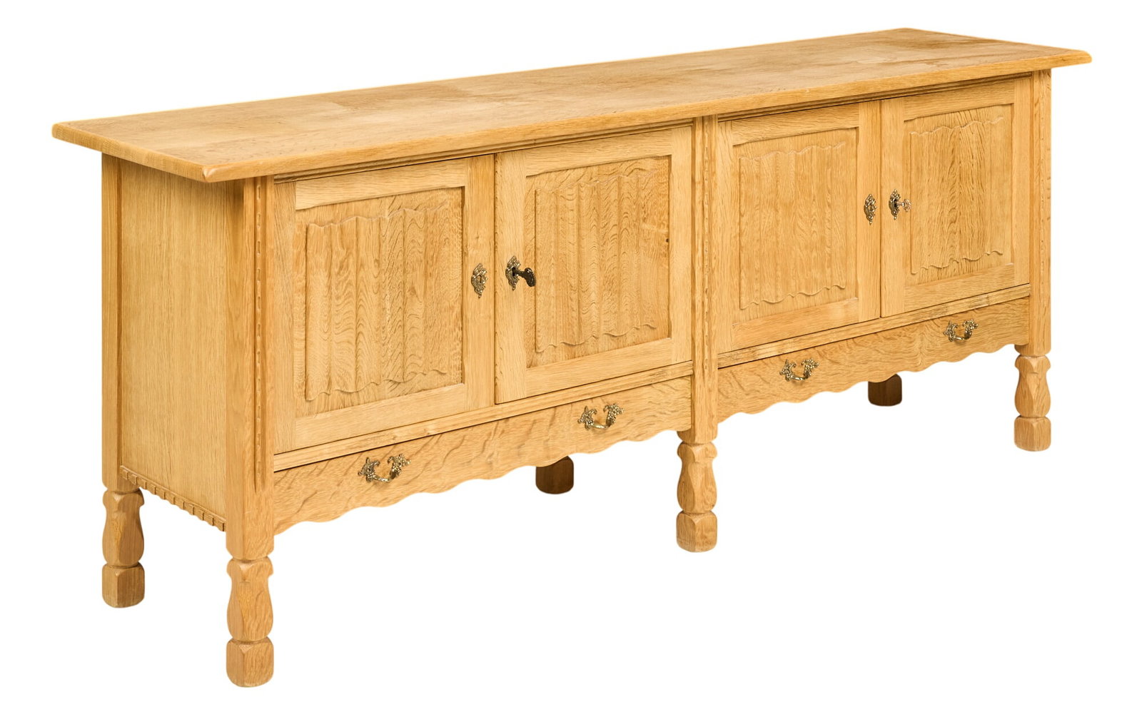 Henning Kjaernulf, Mid-Century Credenza: Henning Kjaernulf (Denmark) oak mid-century credenza with four cabinet doors opening to two shelved interiors above bottom drawers, supported on faceted block legs height 30.5 in. x width 78 in. x