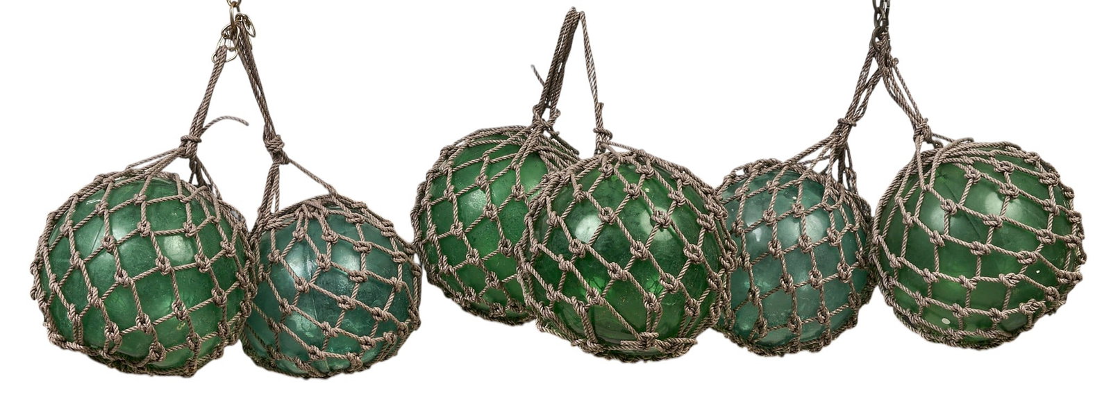 (6) Green Glass Fishing Floats: Set of six vintage green glass fishing floats encased in netting height 19 in. x width 12 in. x depth 12 in. / each Provenance: Property from a home in Rockport, Texas