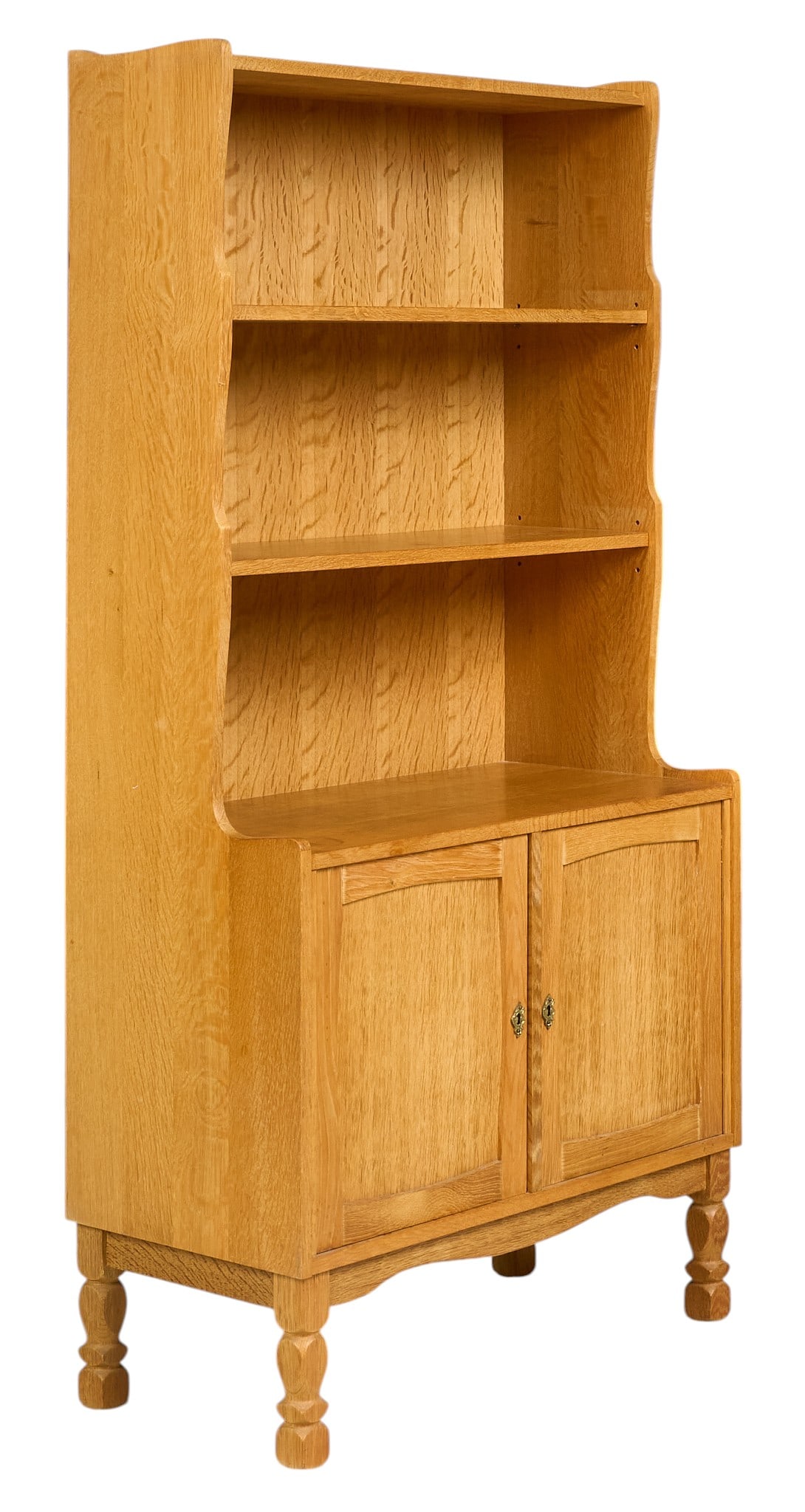 Henning Kjaernulf, Mid-Century Bookcase: Henning Kjaernulf (Denmark) oak mid-century bookcase with two shelves, and lower cabinet, supported on separating base with faceted block legs, with key height 72 in. x width 36 in. x depth 16.5