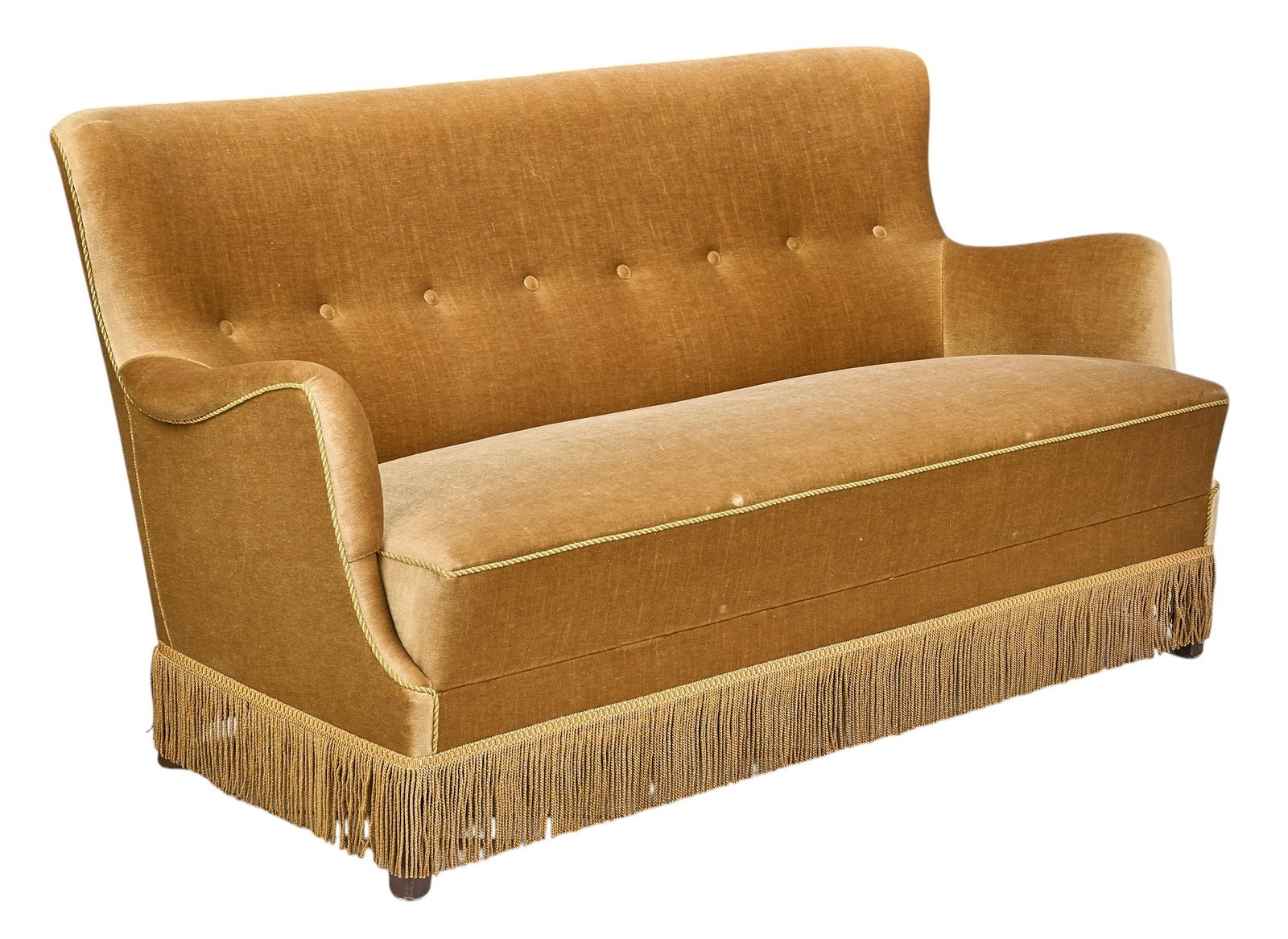 Danish Mid-Century Fringed Sofa: Danish mid-century two-seater sofa upholstered in gold-toned velvet fabric, featuring button-tufted backrest and a decorative fringe along the bottom height 32 in. x width 62 in. x depth 29.5 in.