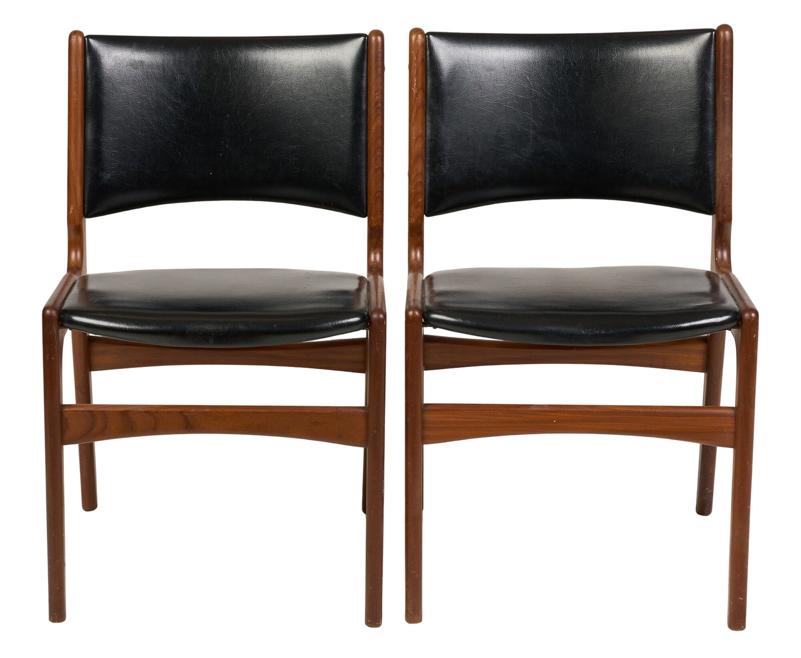 Pair of Mid-Century Leather Chairs: Pair of Danish mid-century dining chairs, with black leather upholstery and stretchered pin legs height 31 in. x width 19 in. x depth 16.5 in. / each