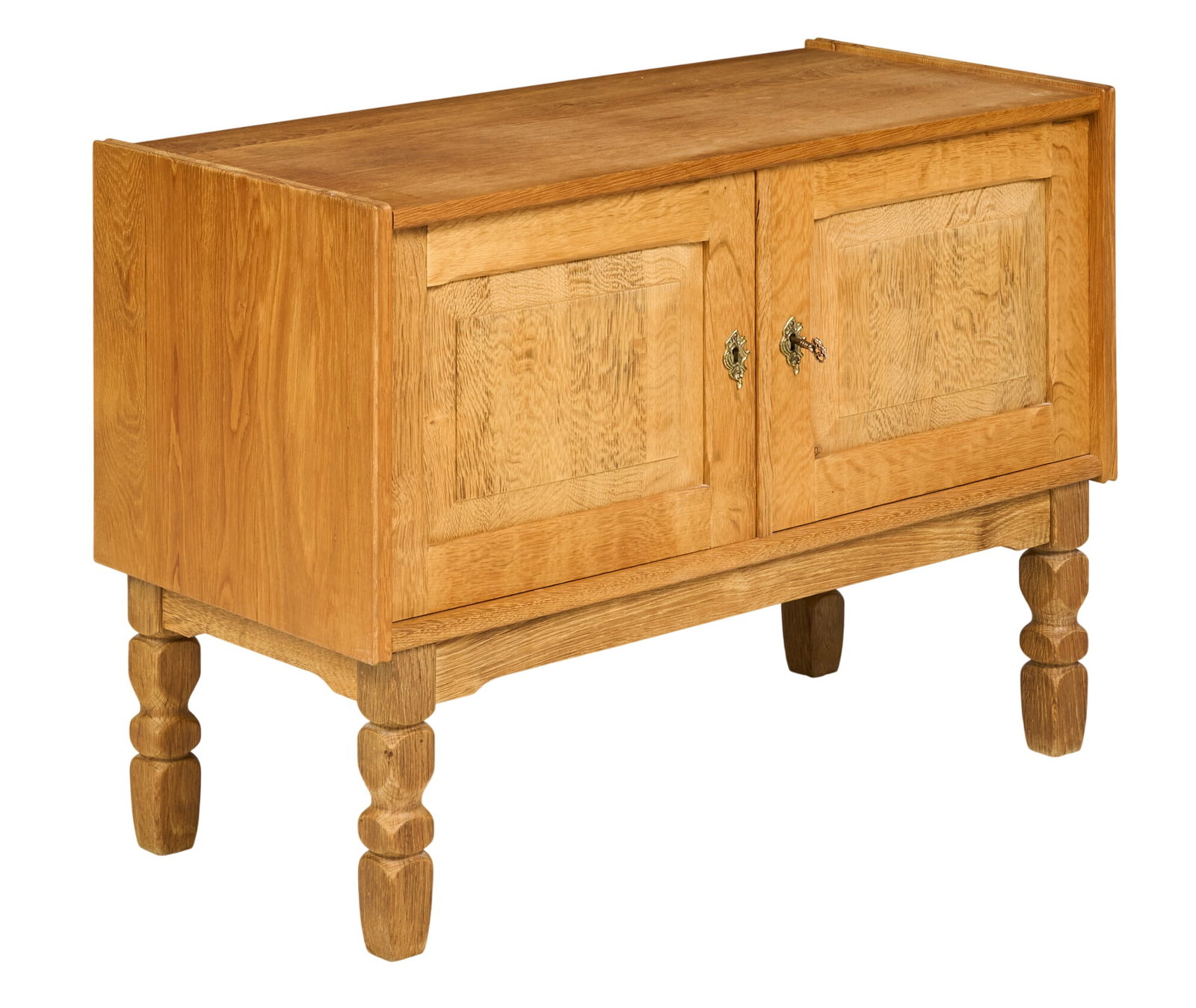 Henning Kjaernulf, Mid-Century Cabinet: Henning Kjaernulf (Denmark) oak mid-century cabinet with single shelf, and key, supported on faceted block legs height 25 in. x width 35.5 in. x depth 16.5 in. 
