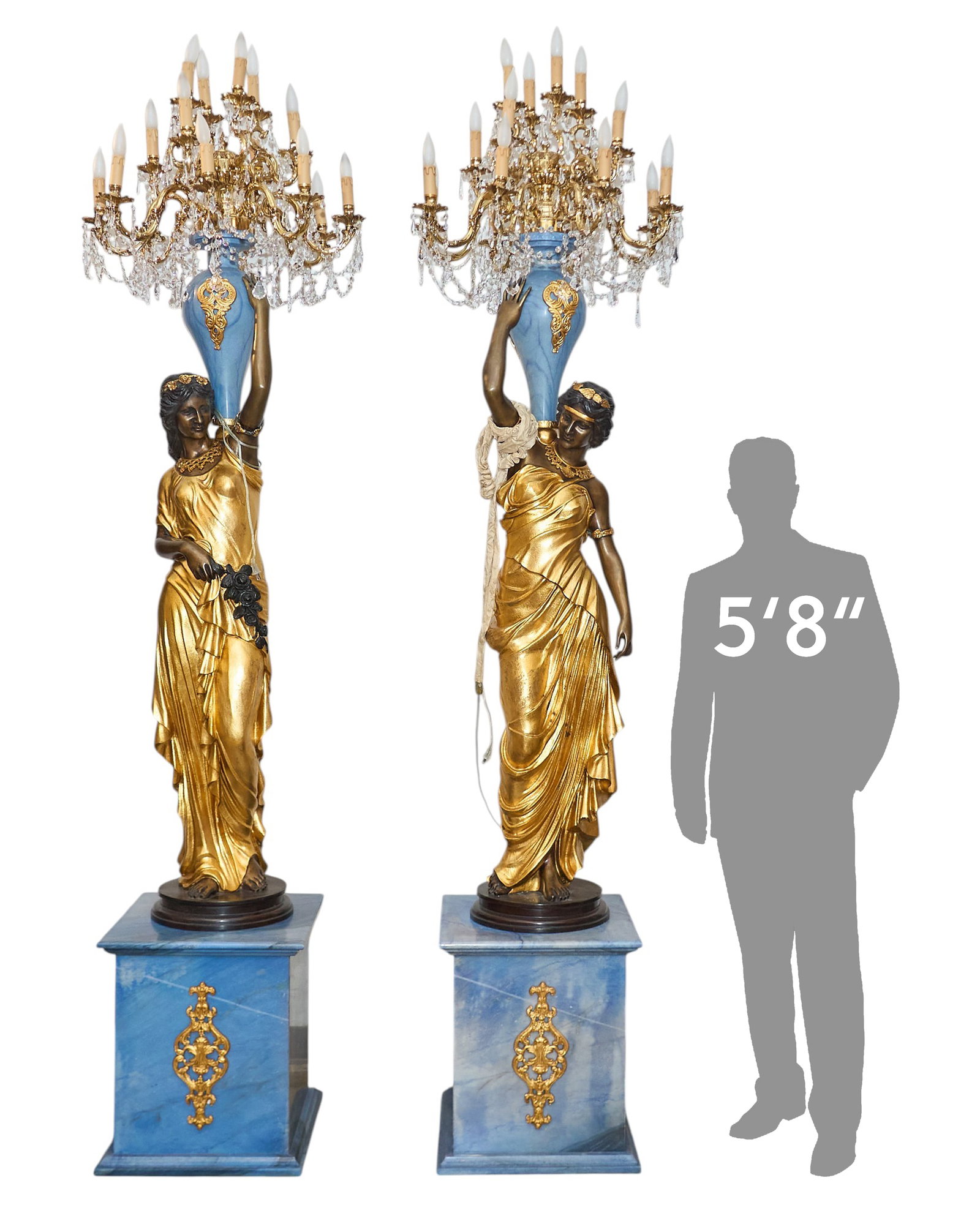 Pair of Ornate Figural Lamps: Pair of monumental figural brass lamps supported on blue stone pedestals height 107.5 in. x width 26 in. x depth 26 in. Provenance: Property from the Estate of Robert A. "Bob" Funk