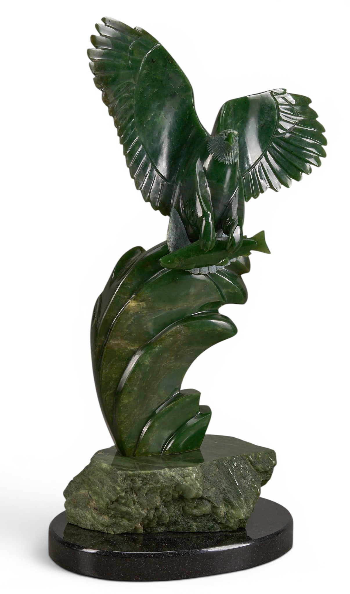 Charles C. Min Hu, Nephrite Jade Eagle Sculpture: Charles C. Min Hu (Canada, 20th century) nephrite jade sculpture depicting eagle with salmon, supported on black stone base, signed on base height 22.5 in. x width 13 in. x depth 7 in. 